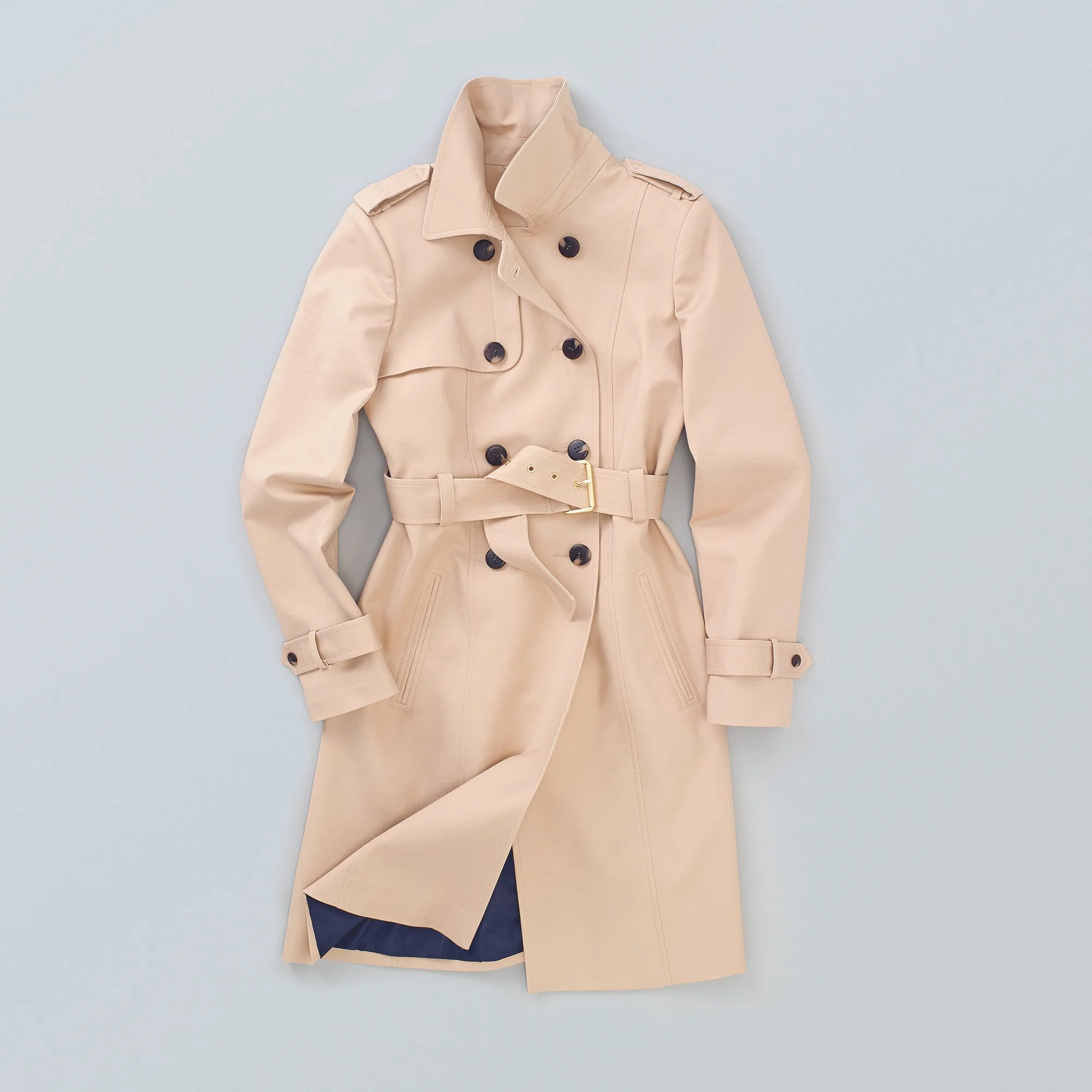 Flat lay still life fashion Women's coat on paste blue background shot overhead in London studio 