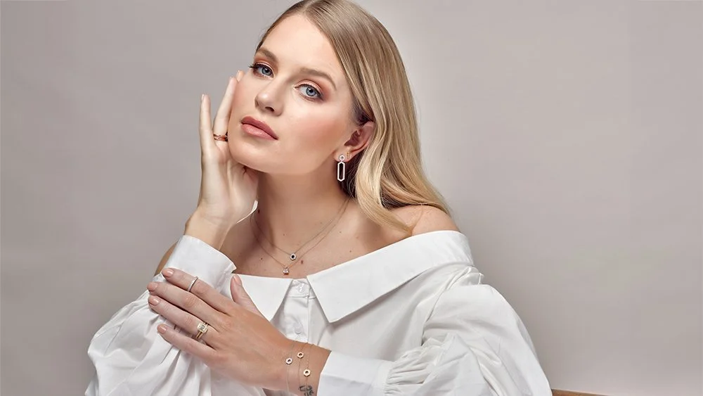 ecommerce jewellery on model 3/4 shot of model sitting looking at camera