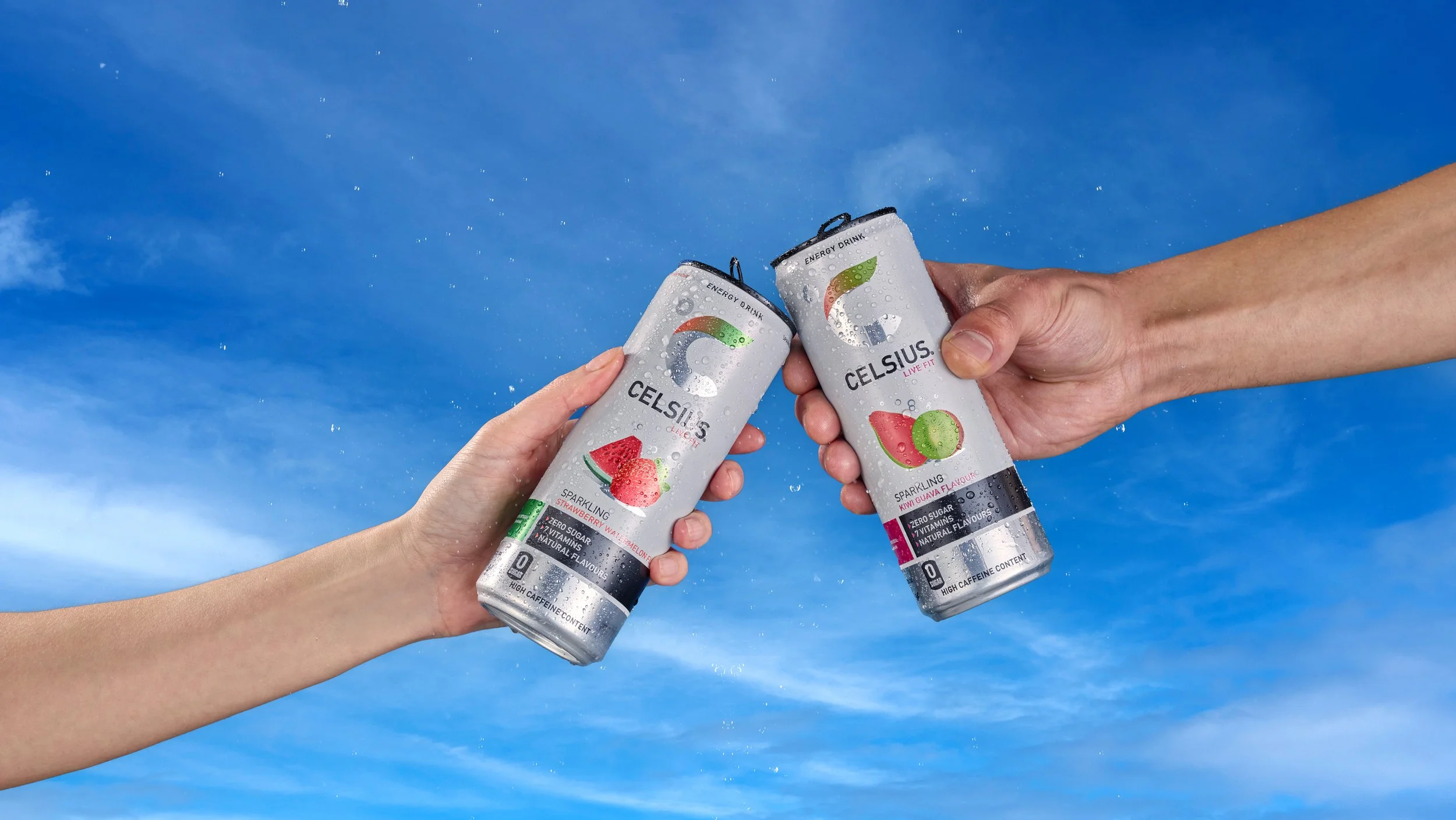 lifestyle shot of two people connecting with drinks can together