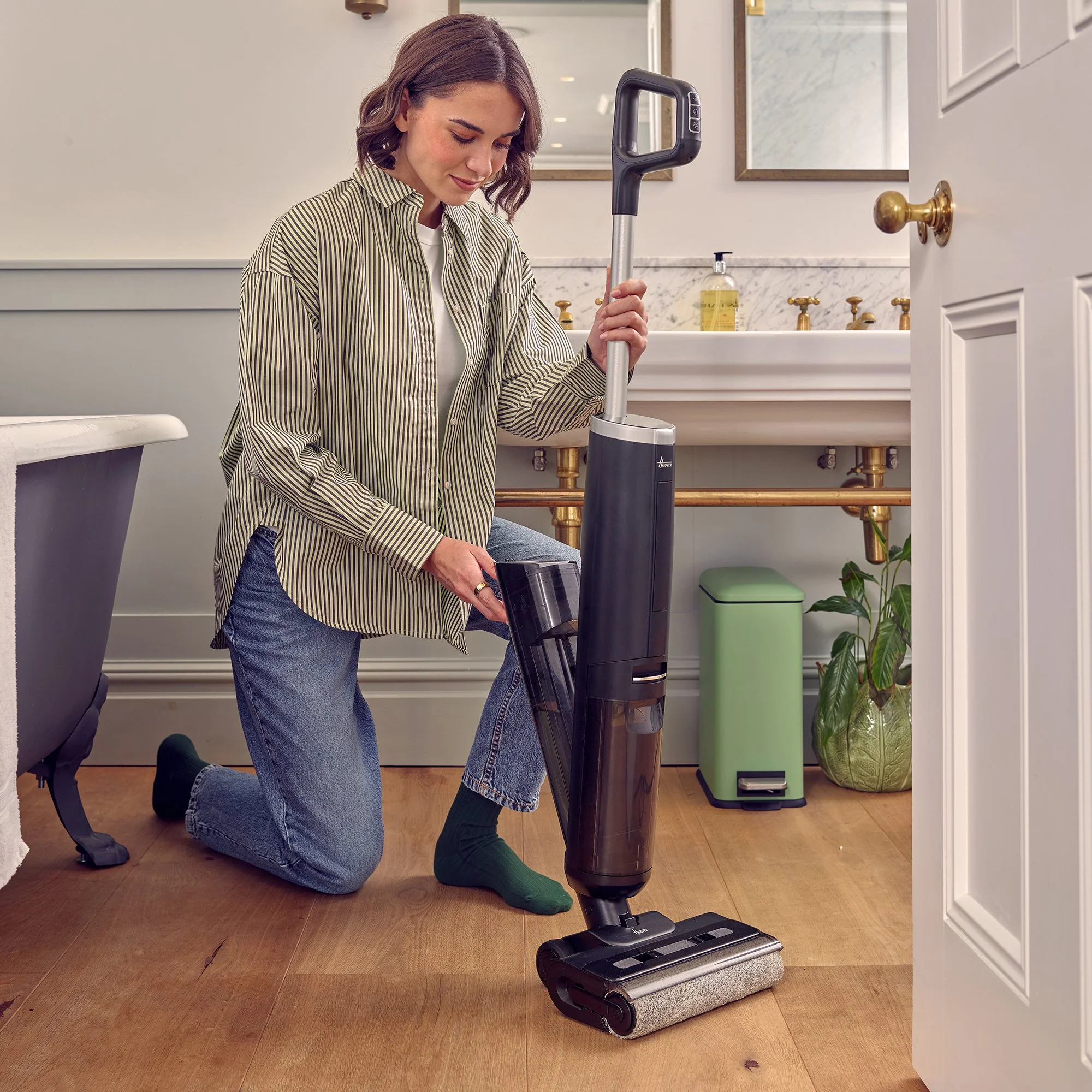 commercial still life photographer capture model in bathroom with a vacume cleaner