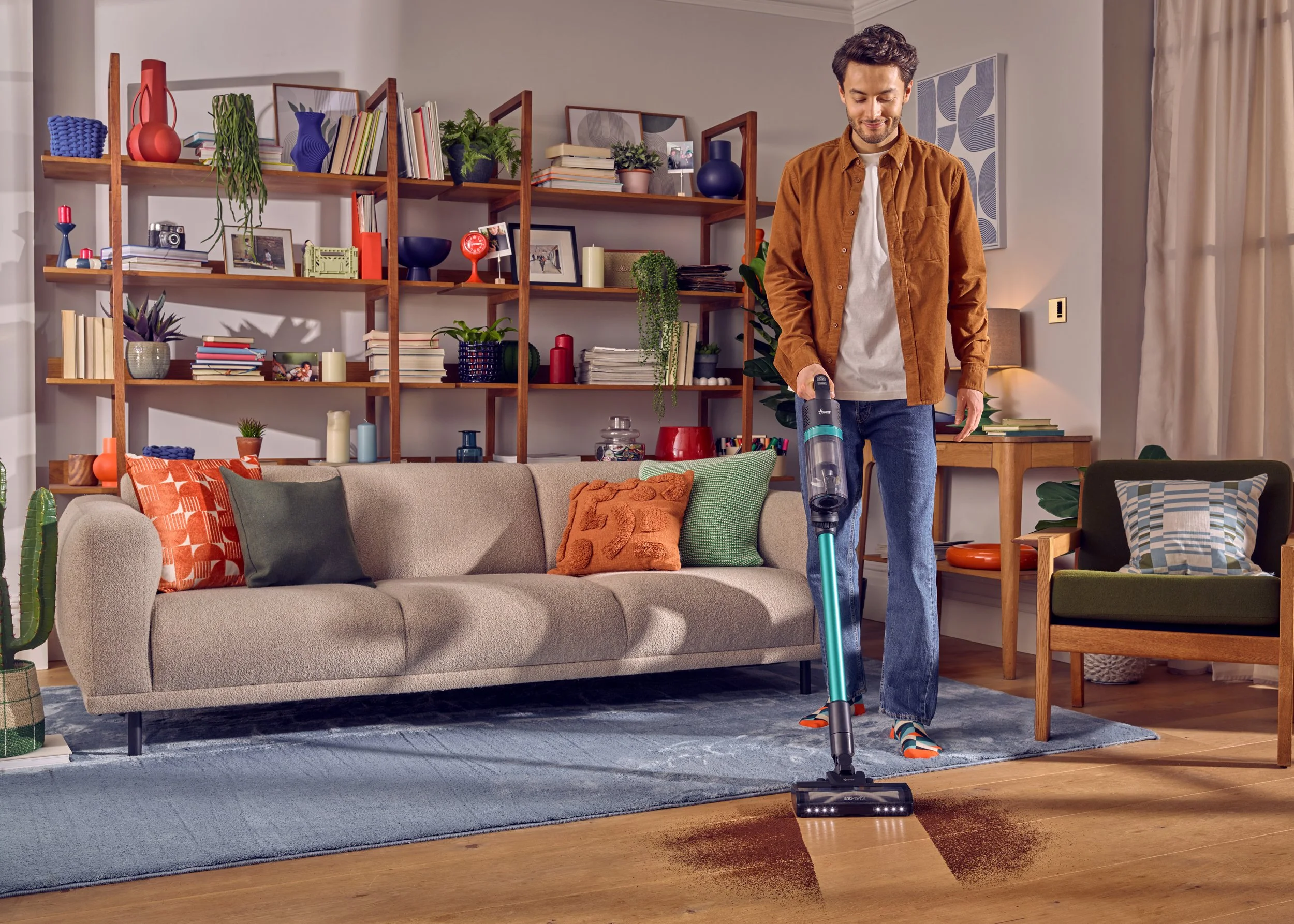 Man hoover living room with natural light shot by commercial advertsing product photogrpher