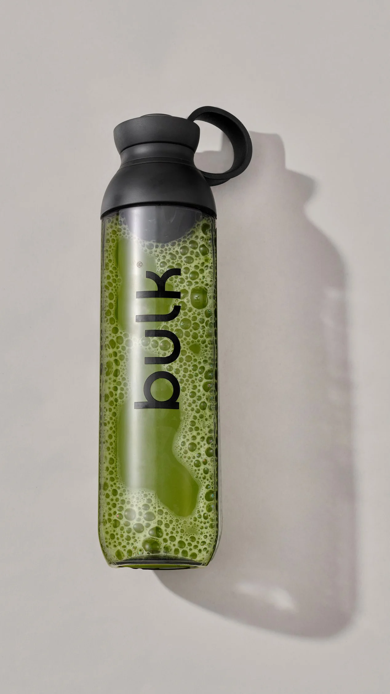 water bottel on plan background with large shadow for drink product packaging photography 