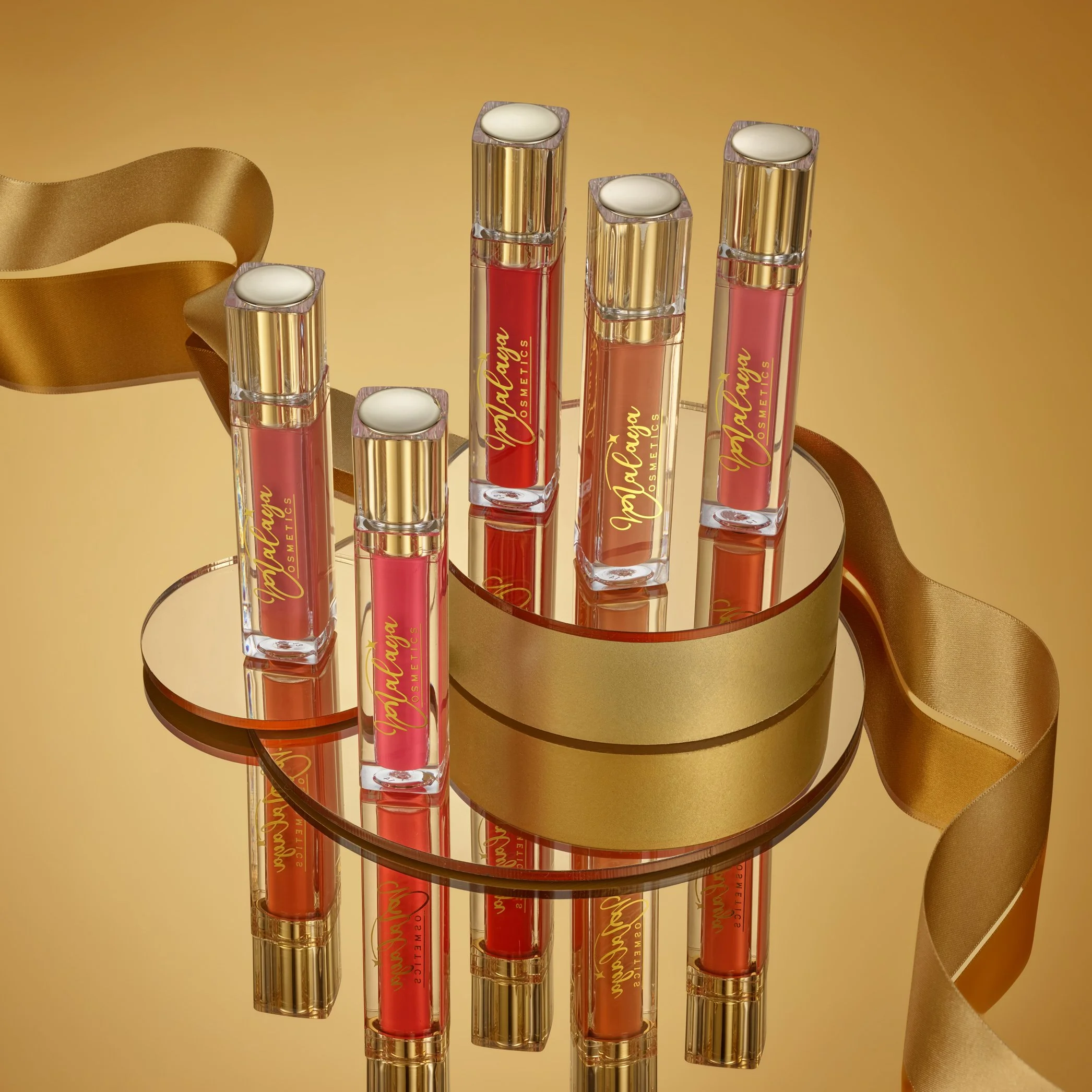 Gold Cosmetic Collection Lipbalms with ribbon still life