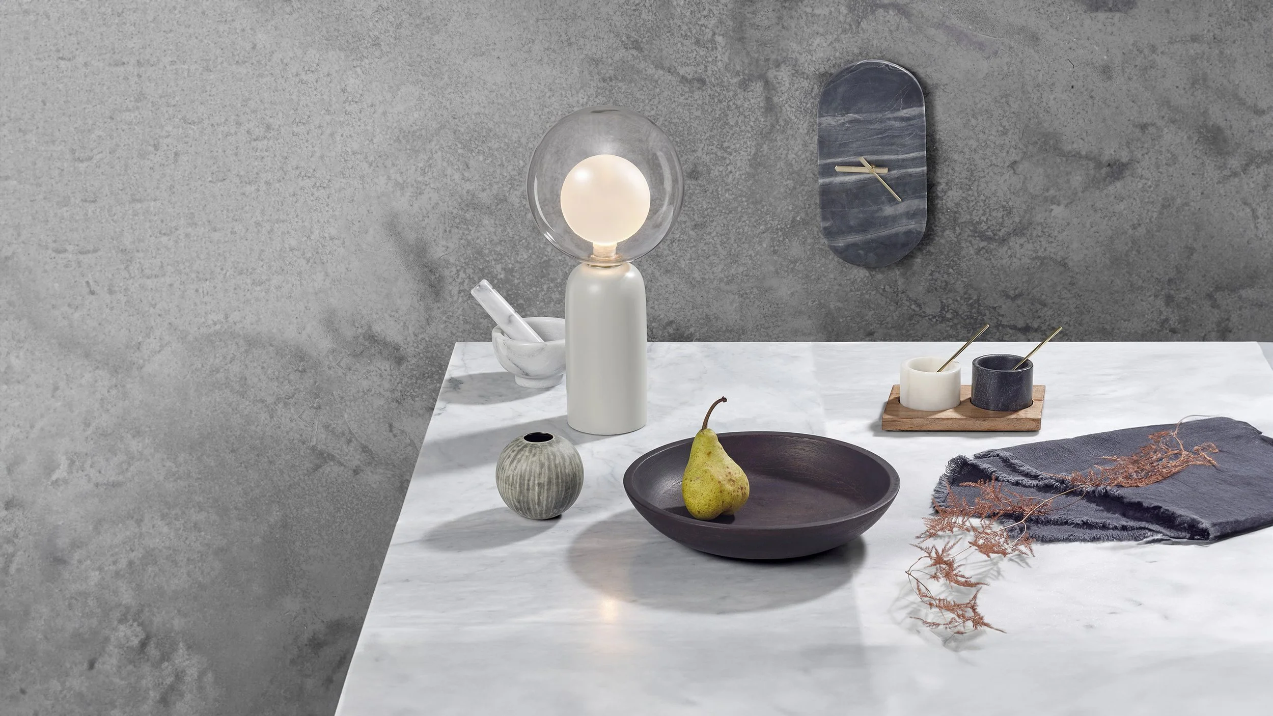 lifestyle still life setup with homeware products on marble table 