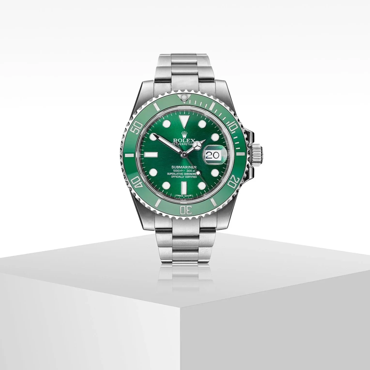 green face Rolex sits onto of grey plinth
