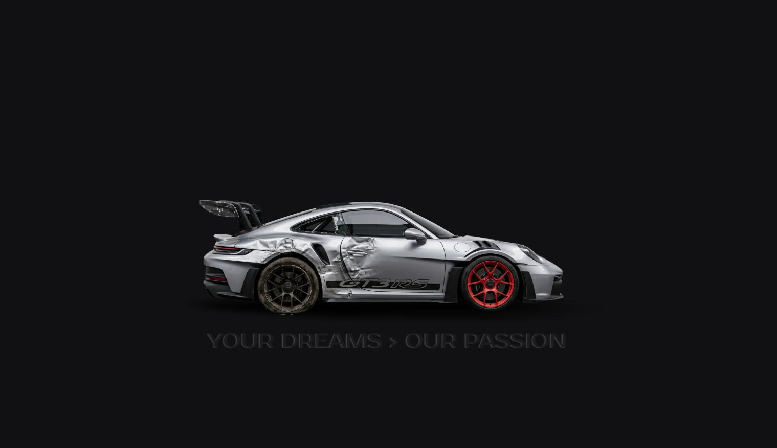 A damaged silver Porsche 911 GT3 RS race car with a red front wheel, black rear wheel, and a large rear spoiler, displayed against a black background with the text 'Your Dreams > Our Passion' below.