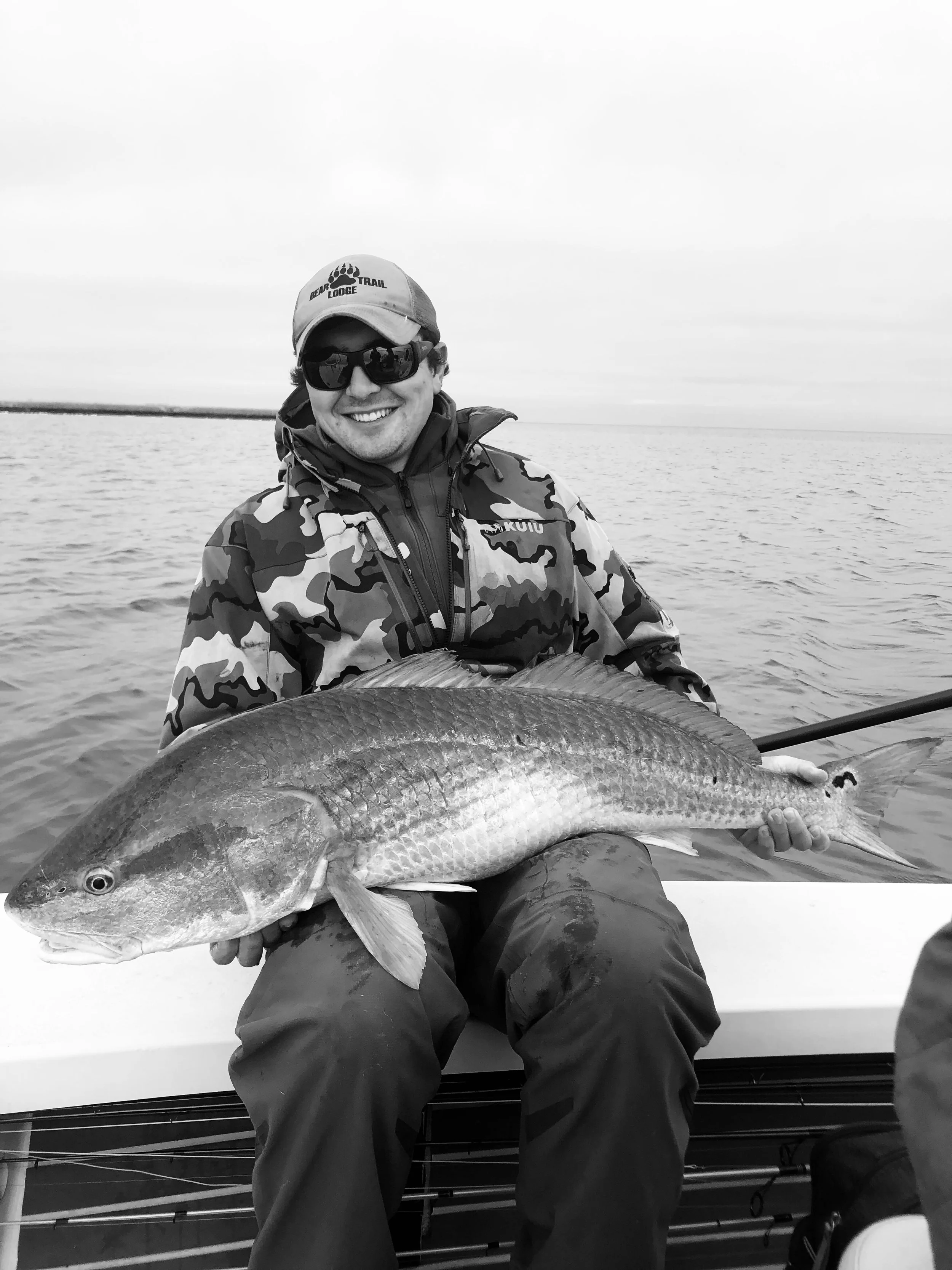 Client fighting fish on spinning rod in Louisiana marsh
