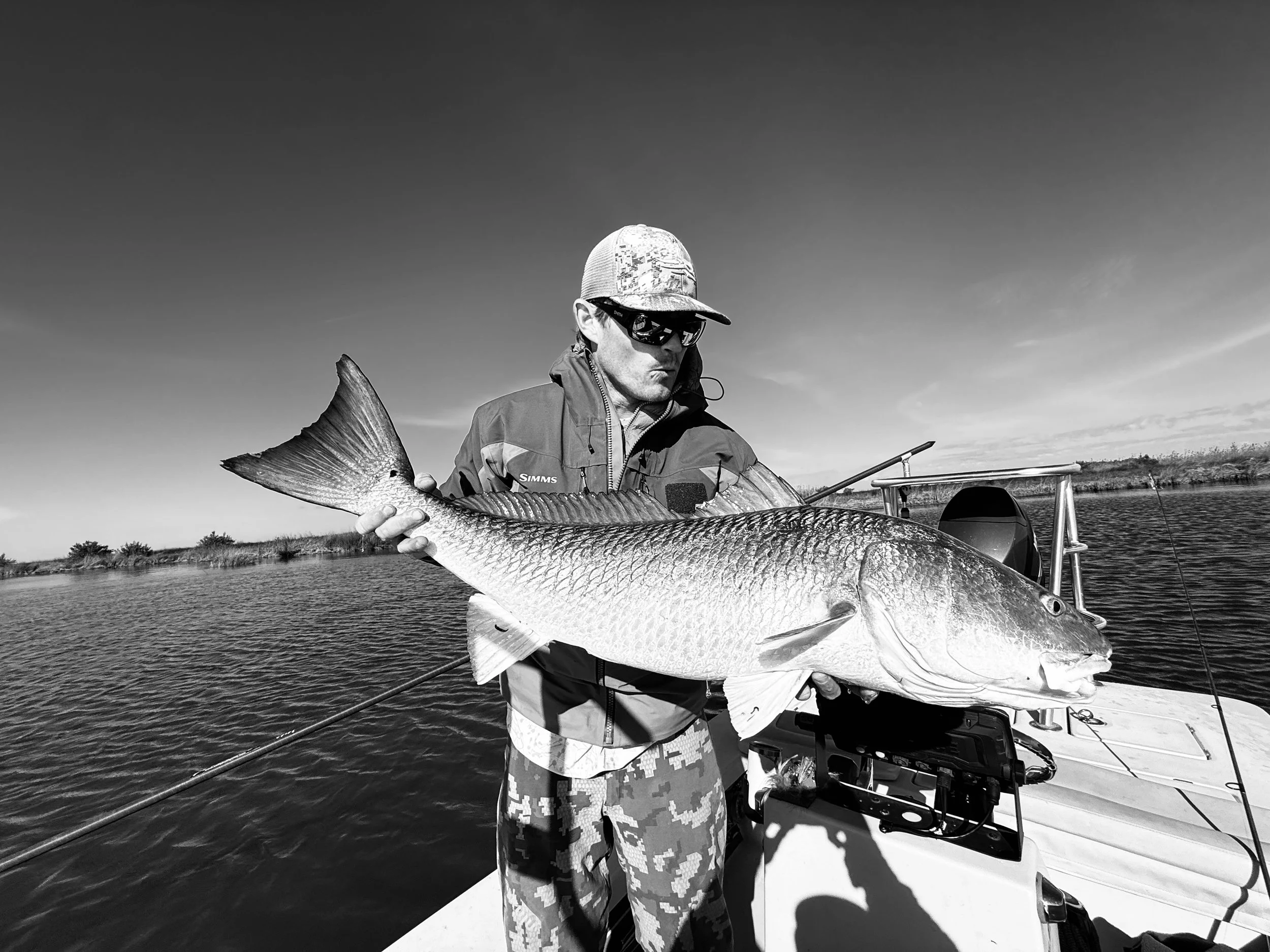 Holding large bull redfish for client. 