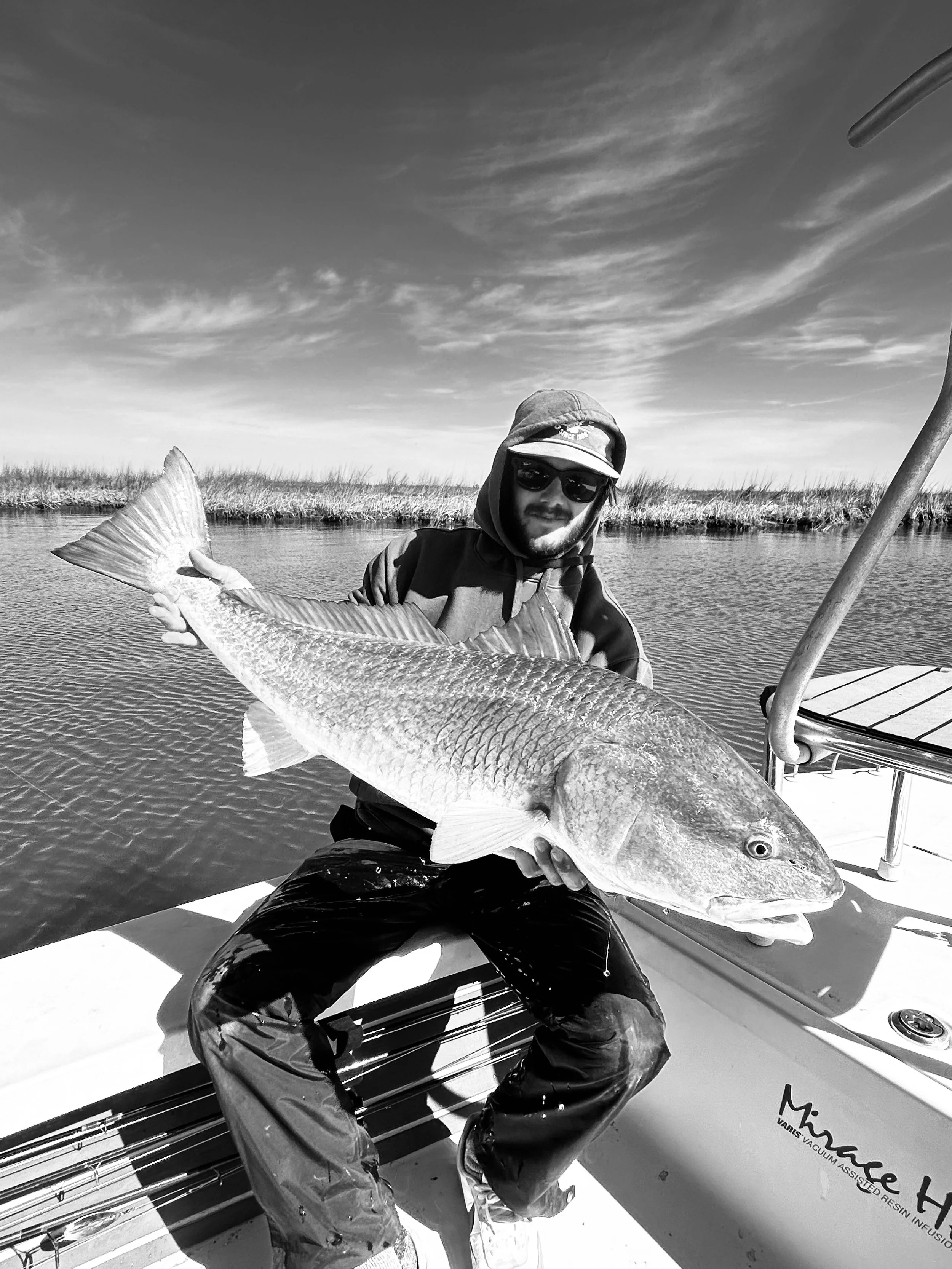“Louisiana marsh grass and calm water where redfish are commonly found.”