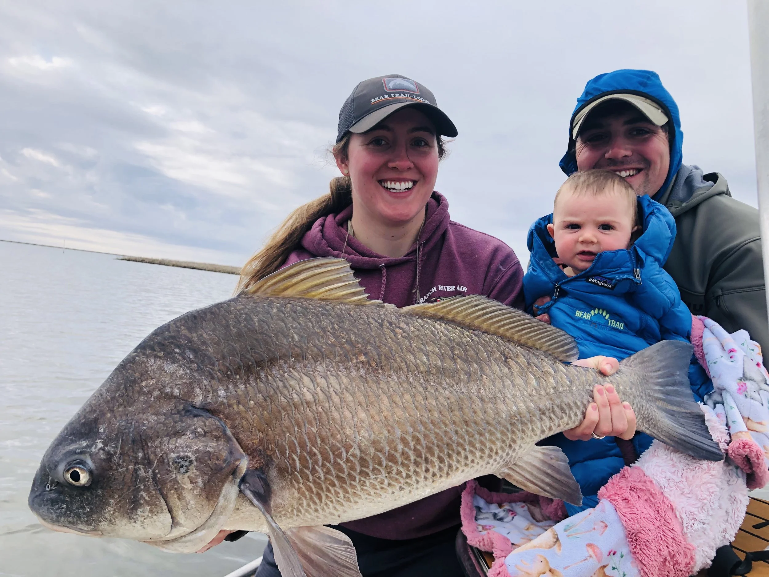 Family enjoying fishing with a baby on board. 