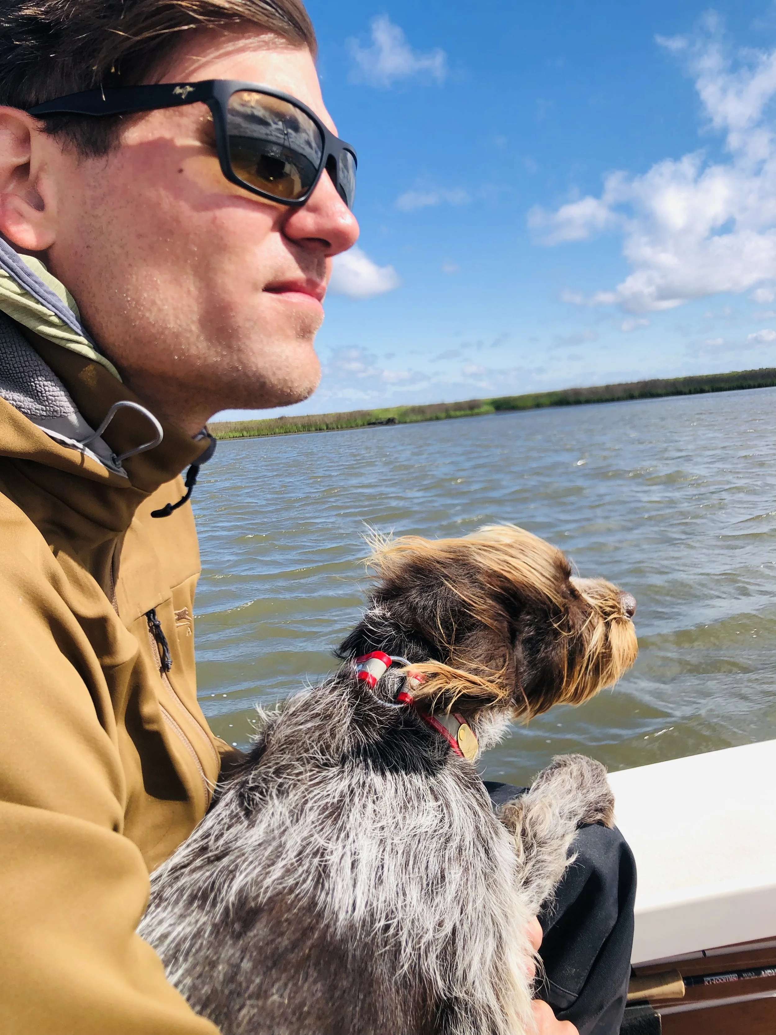 Focused angler while running center console fishing boat 
