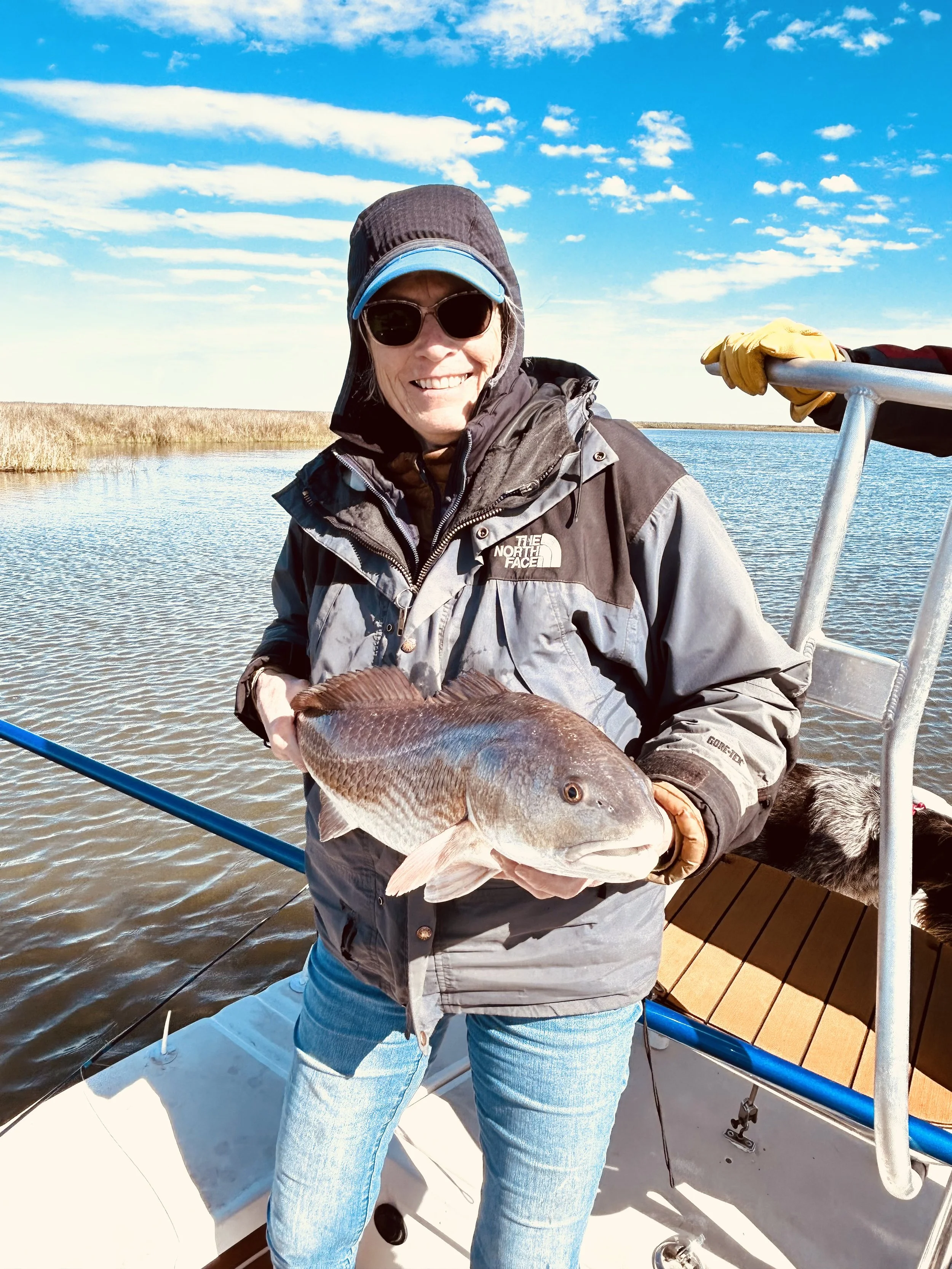 Woman holds her first redfish catch ever 
