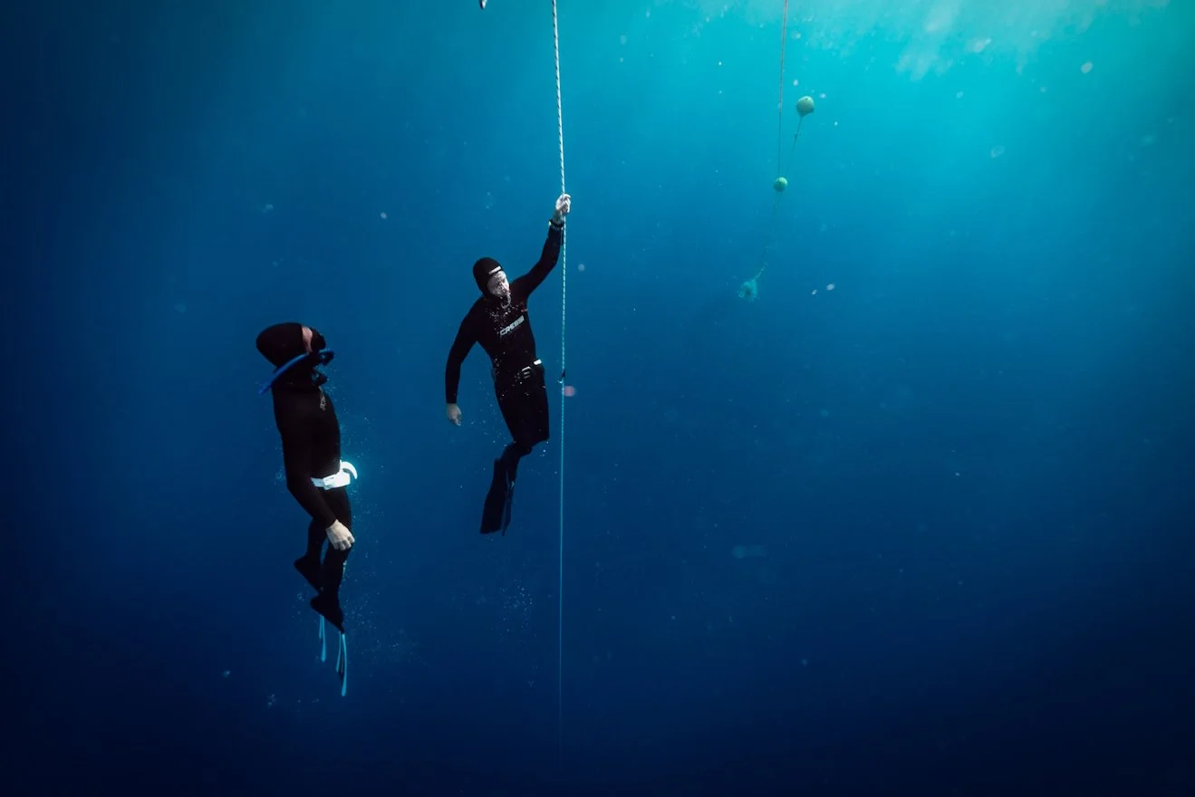 Two freedivers training along a line in Tenerife