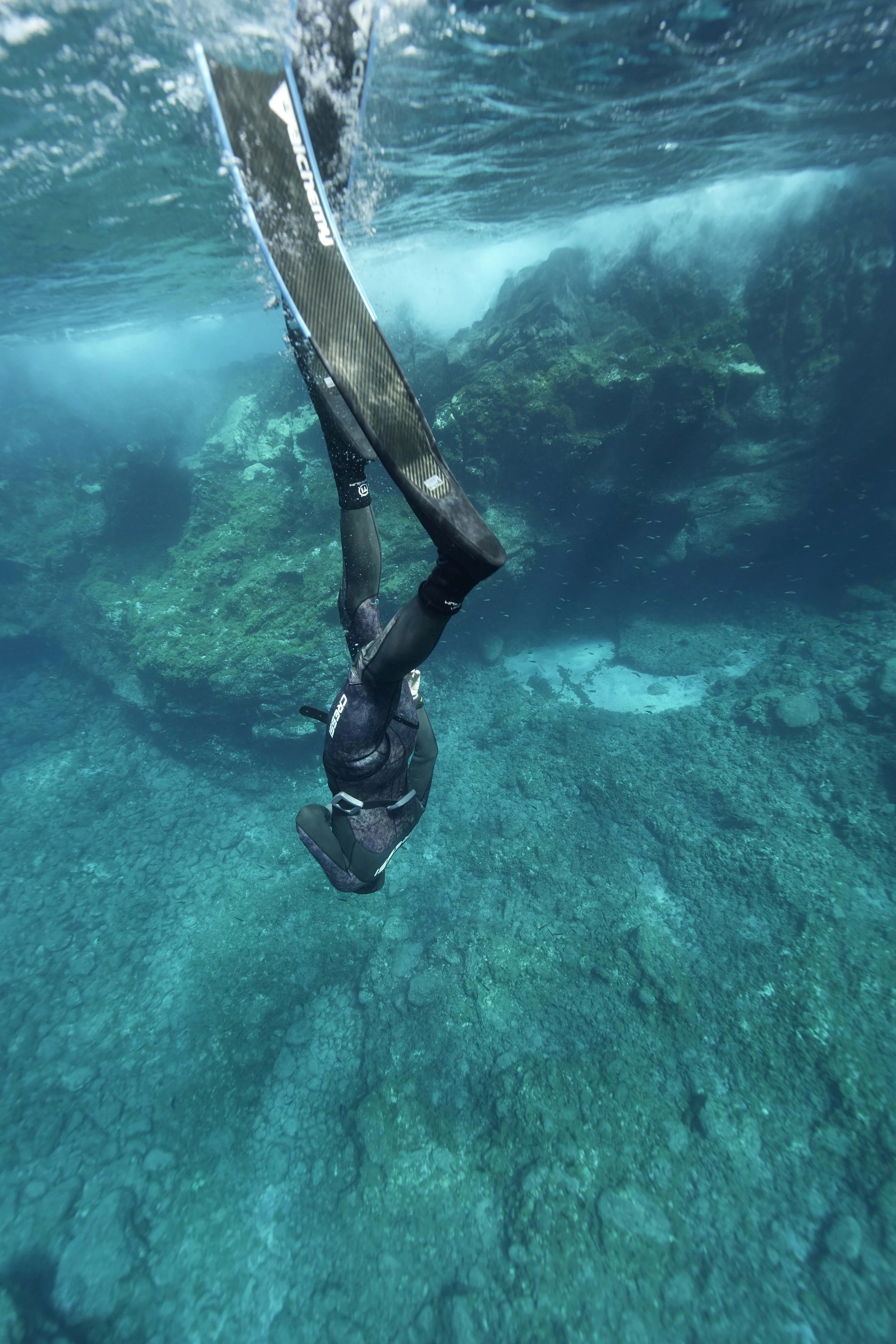 A freediver going headdown to the bottom of the ocean floor in Tenerife