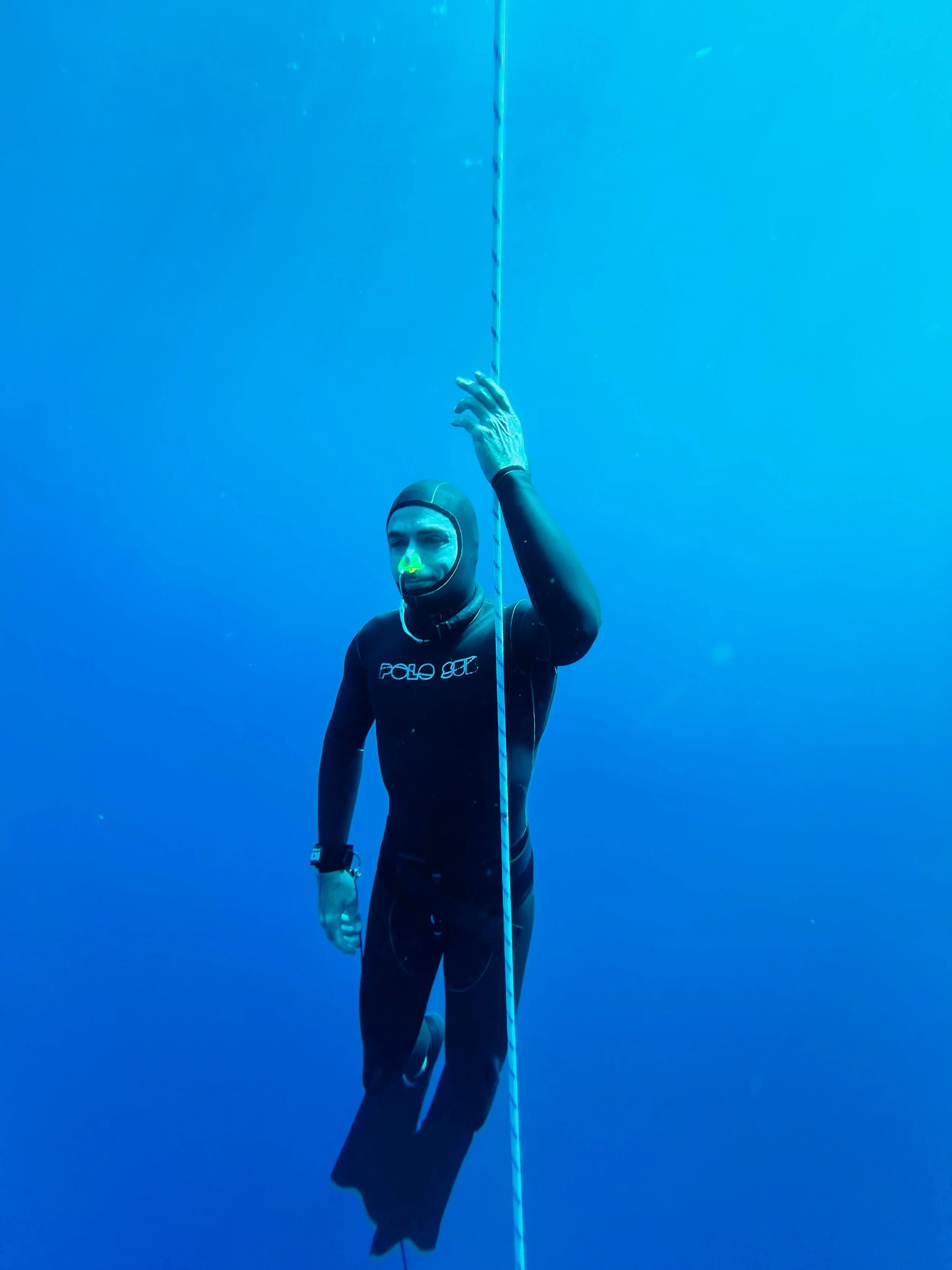 A freediver ascending from his dive, along the line in Tenerife
