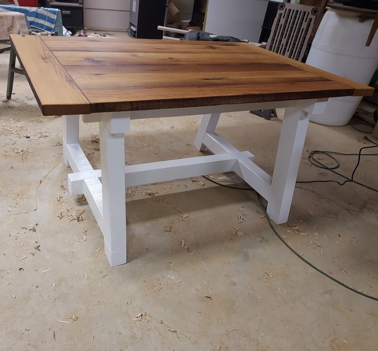 We are so proud of this custom-built farmhouse-style dining table &ndash; a unique and stylish piece with rustic charm. With rough-cut maple legs, a reclaimed white oak top, and elegant walnut accents, it was a beautiful project that we loved working