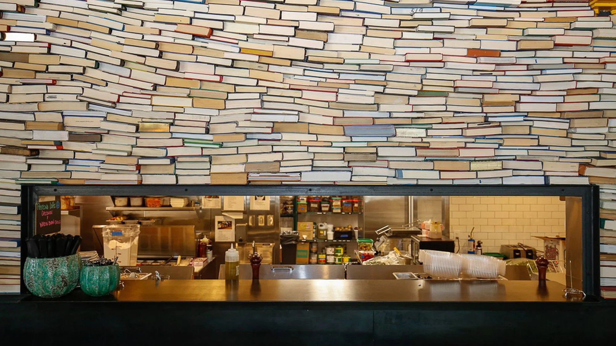 A stacked wave of books acknowledge the Denver Lohi building's former life as a book bindery