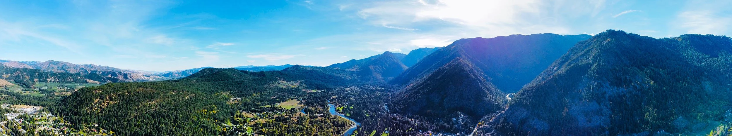 Professional real estate media by Volo Foto — photography, video, virtual tours, floor plans, and FAA Part 107 certified drone services in Sacramento, Elk Grove, Galt, and Lodi — drone arial panorama of mountains and valley Leavenworth, Washington.