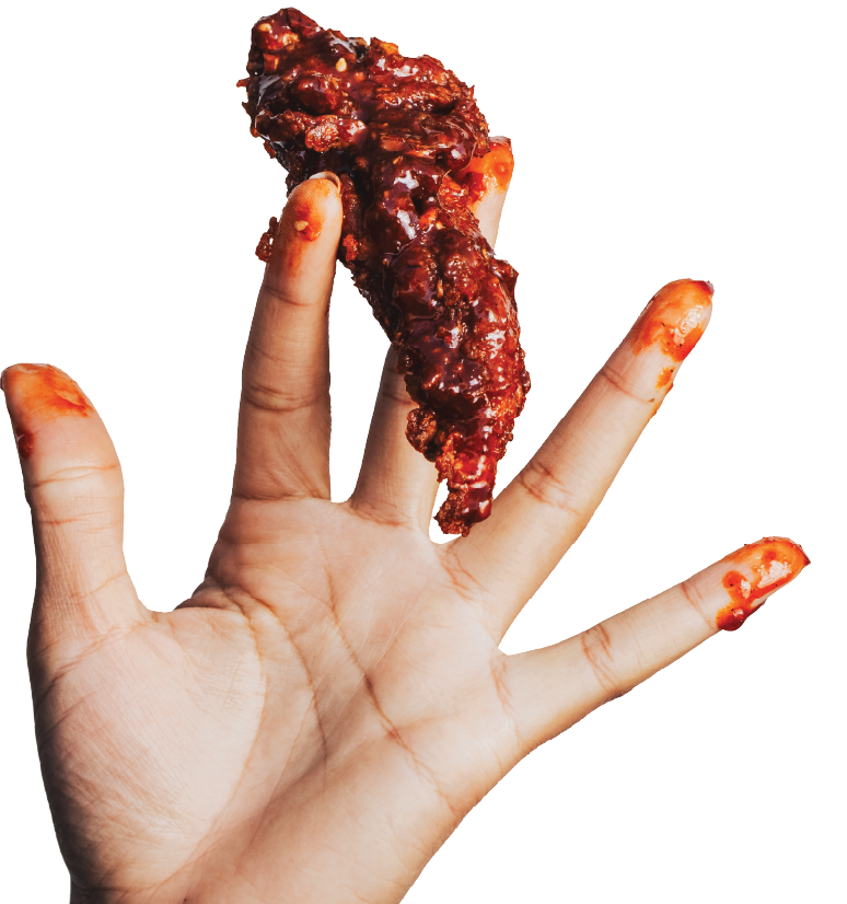 Hand holding a crispy chicken tender coated in teriyaki sauce