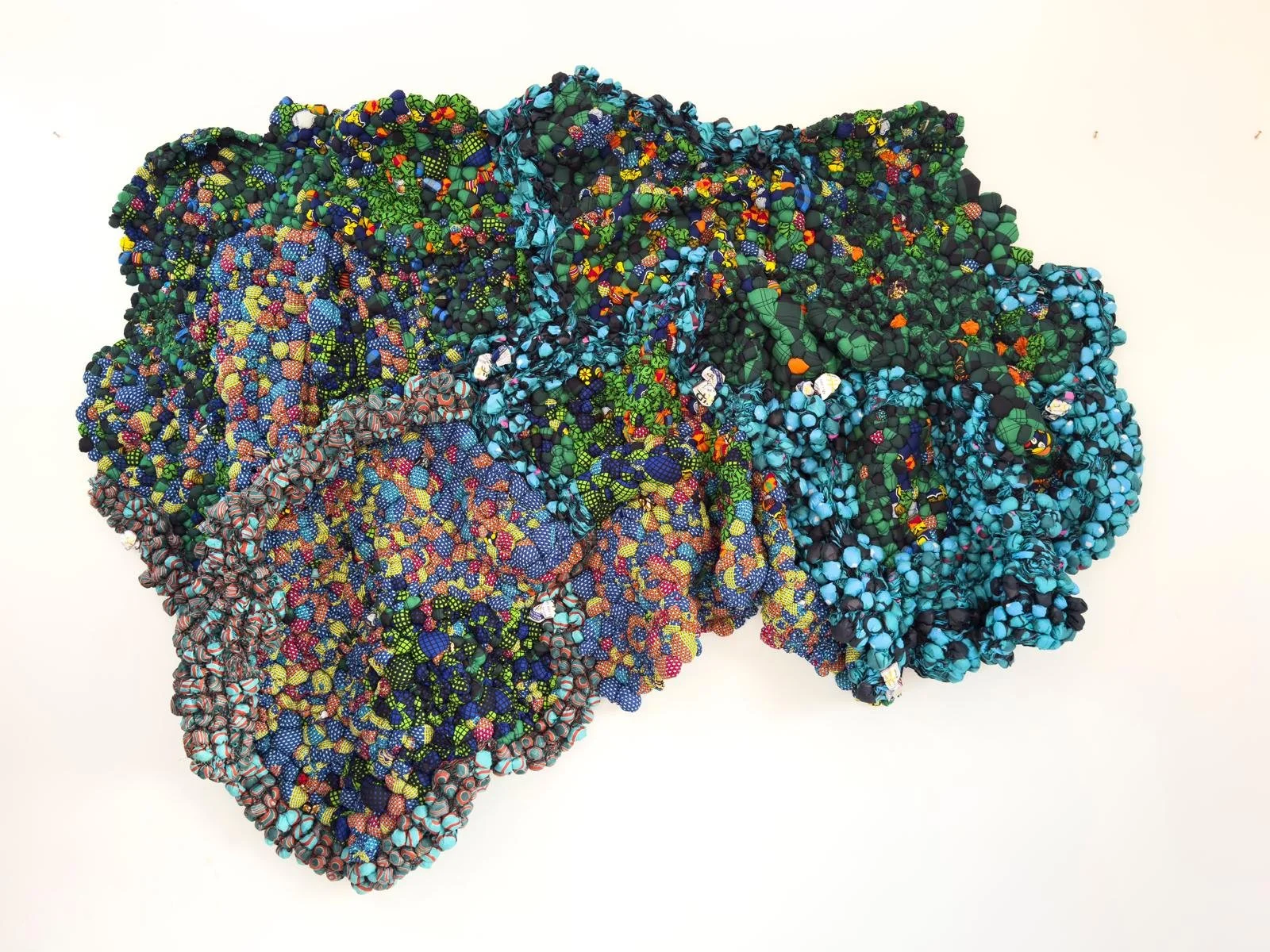 The Land is Fertile , 2024, African Print Fabric, 114" x 78" x 10"