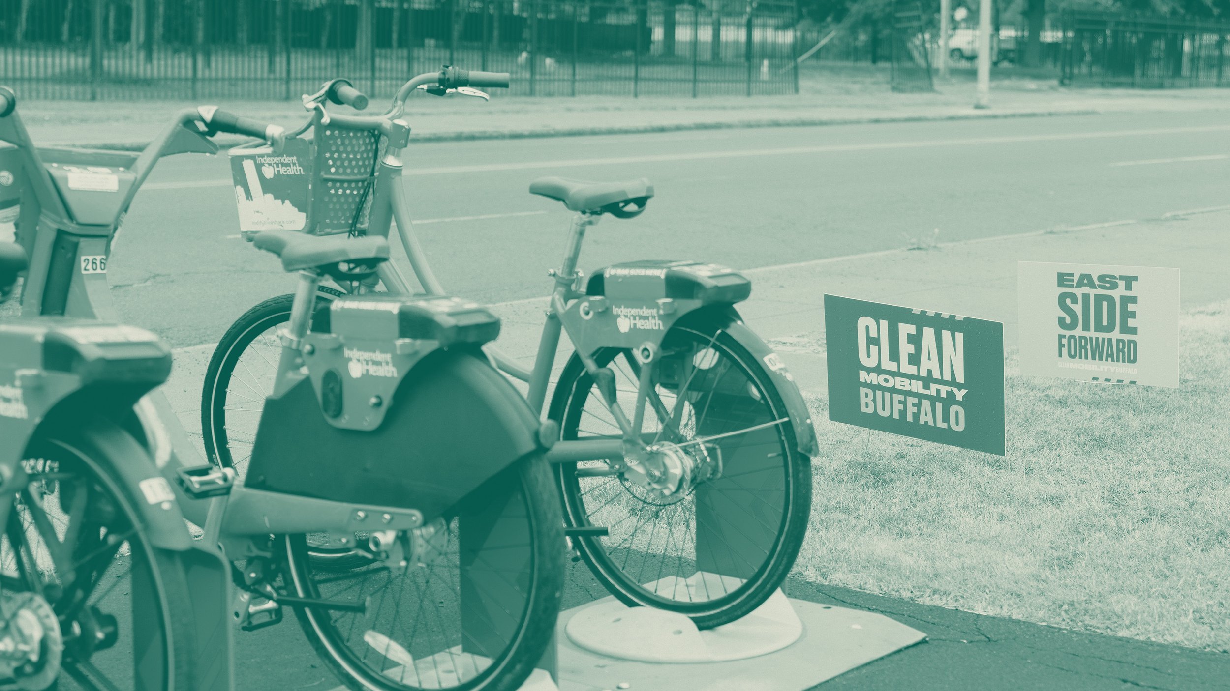 reddy bikeshare bikes next to clean mobility buffalo lawn signs