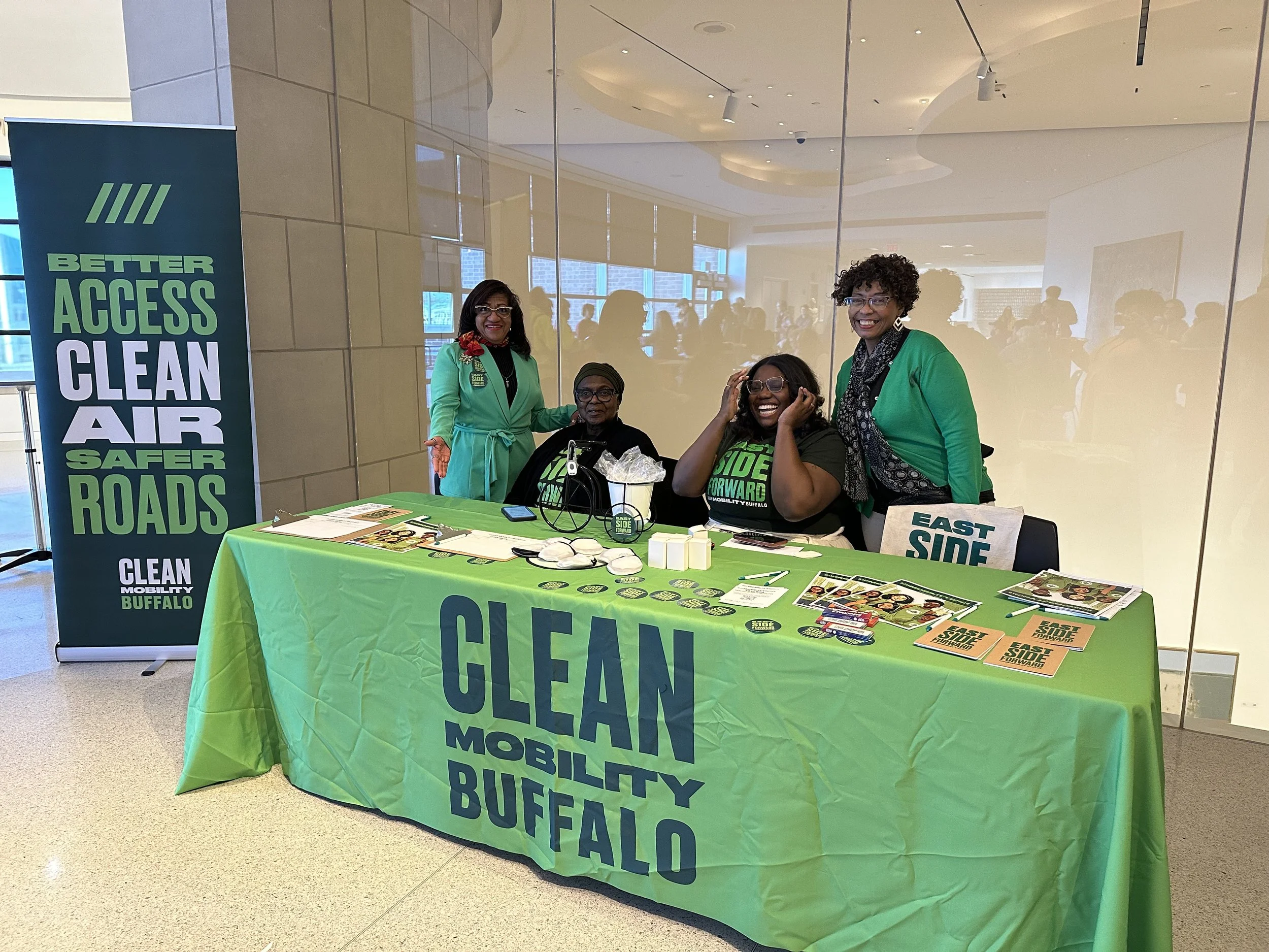 Neighborhood Leadership Group at Ride Reels — An image of a table and folks behind it for Clean Mobility Buffalo.