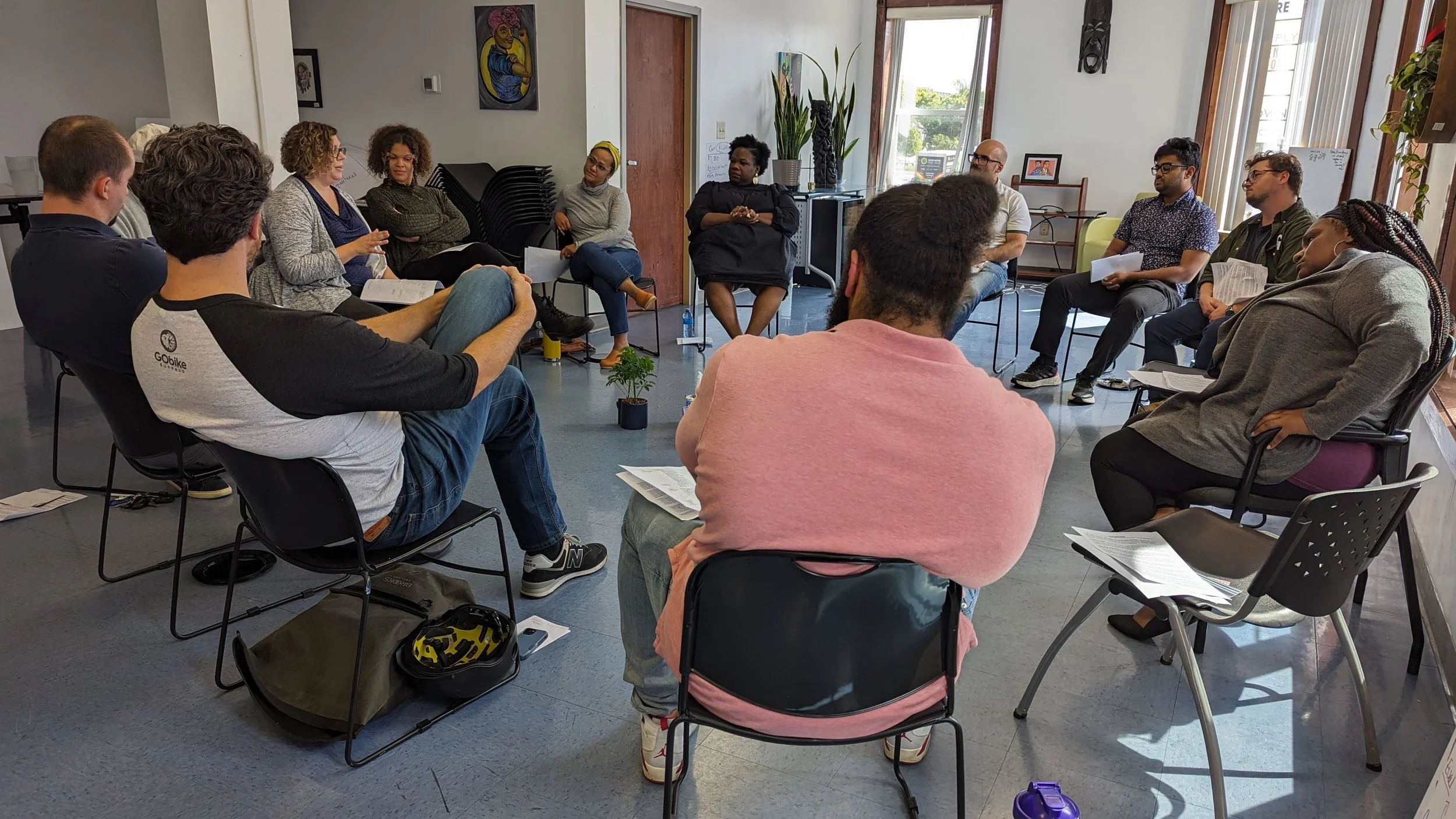 Racial Healing Circles group exercise — A photo of a group of people sitting in fold out chairs in a circle. 