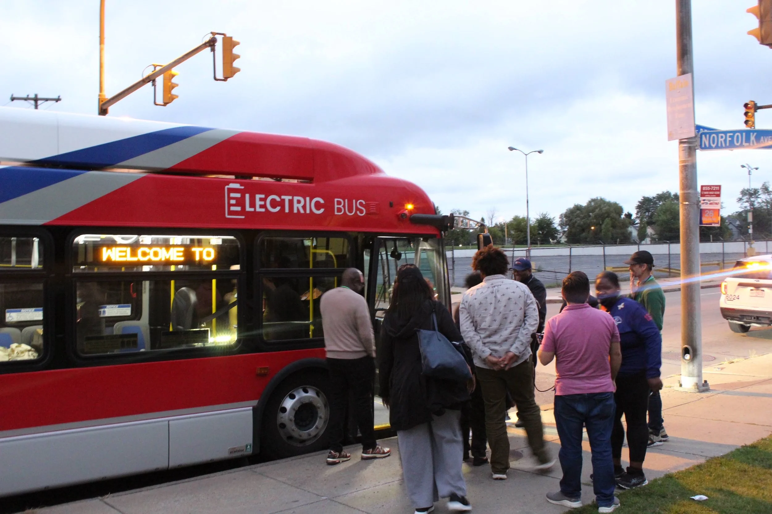Clean Mobility - Neighborhood Leadership Group - Eco Justice Bus Tour 8/30/2023 — A group of people getting on an electric NFTA bus.