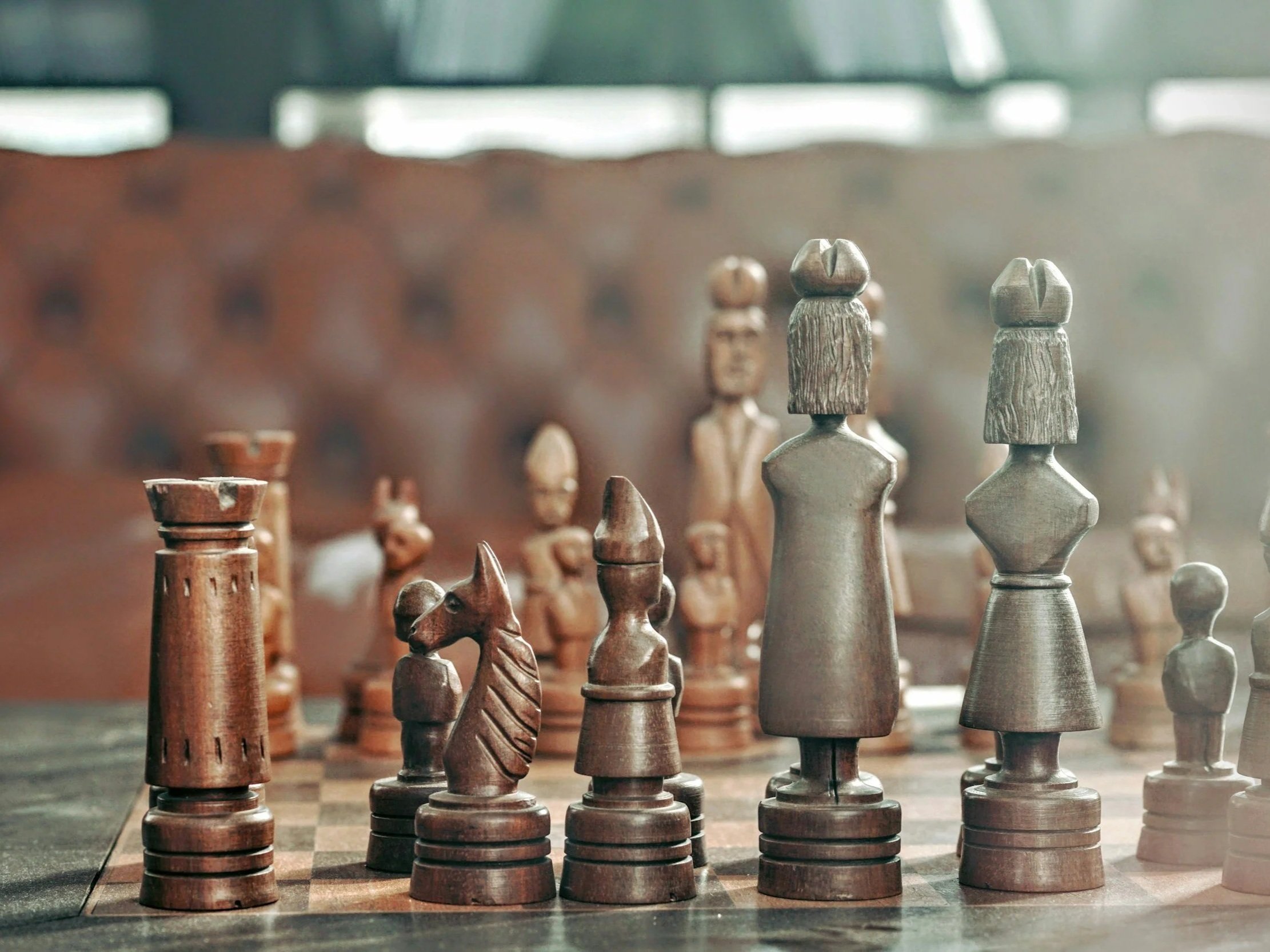 wooden chess pieces on a board