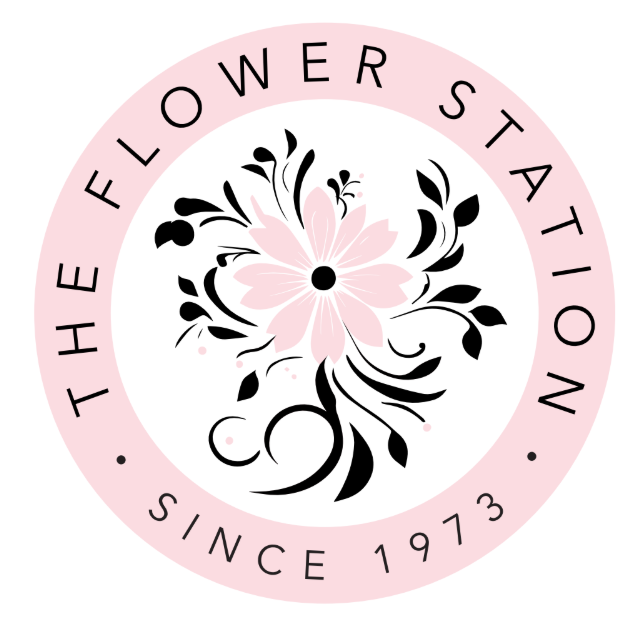A circular logo with the text 'The Flower Station Since 1973' around a pink flower with black and pink decorative elements.