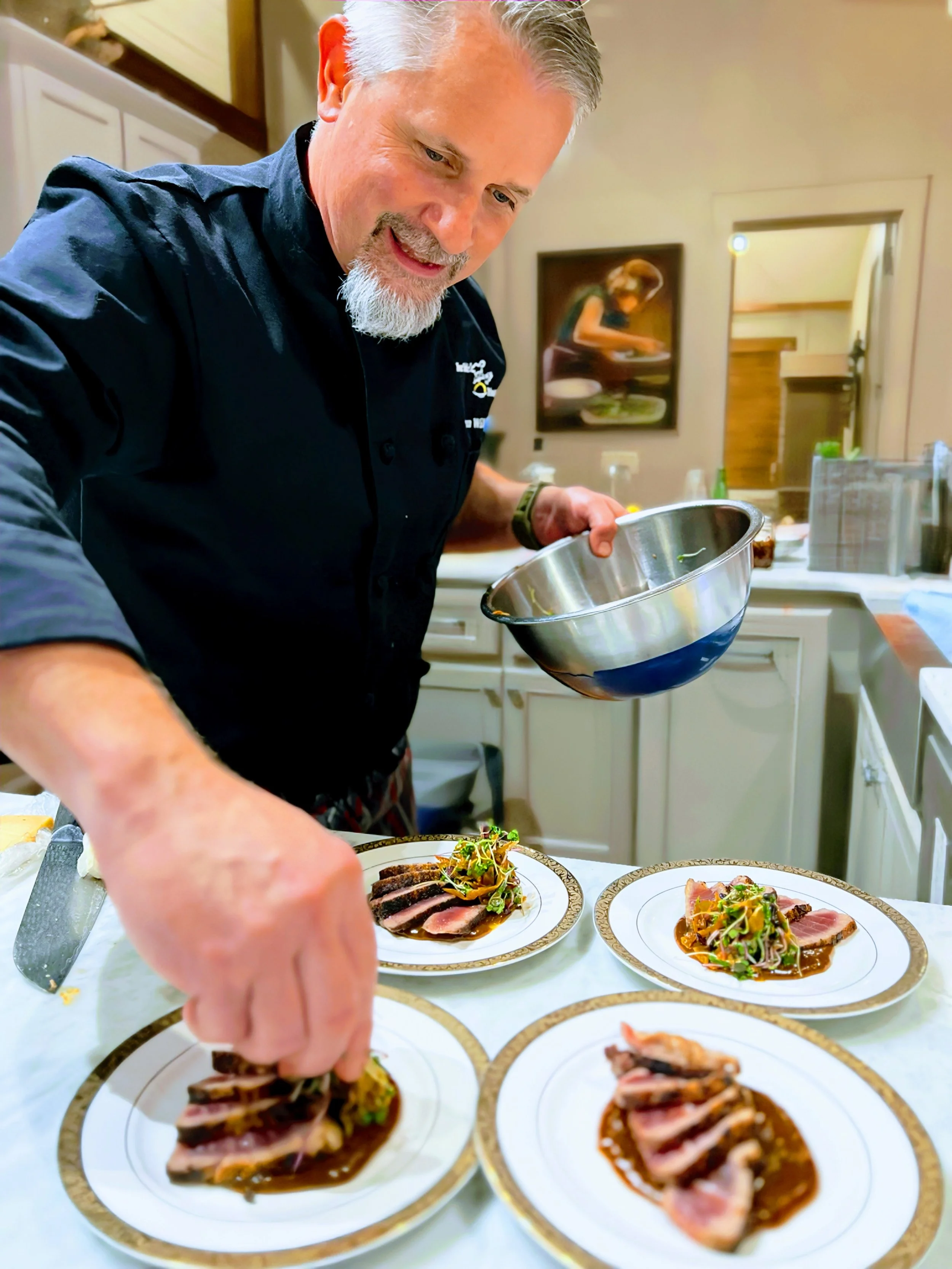 Chef Ian happy at work preparing a dish in a customer's kitchen