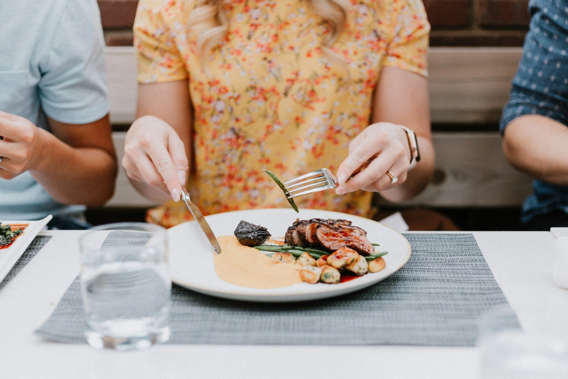 Woman sitting down preparing to eat her meal and properly digest her food.