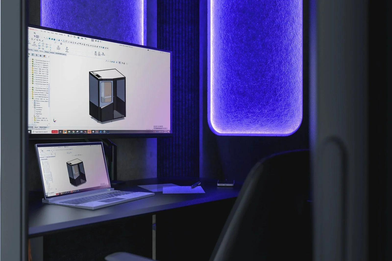 MeSpace interior lit in full RGBW color, monitor and laptop on the desk.