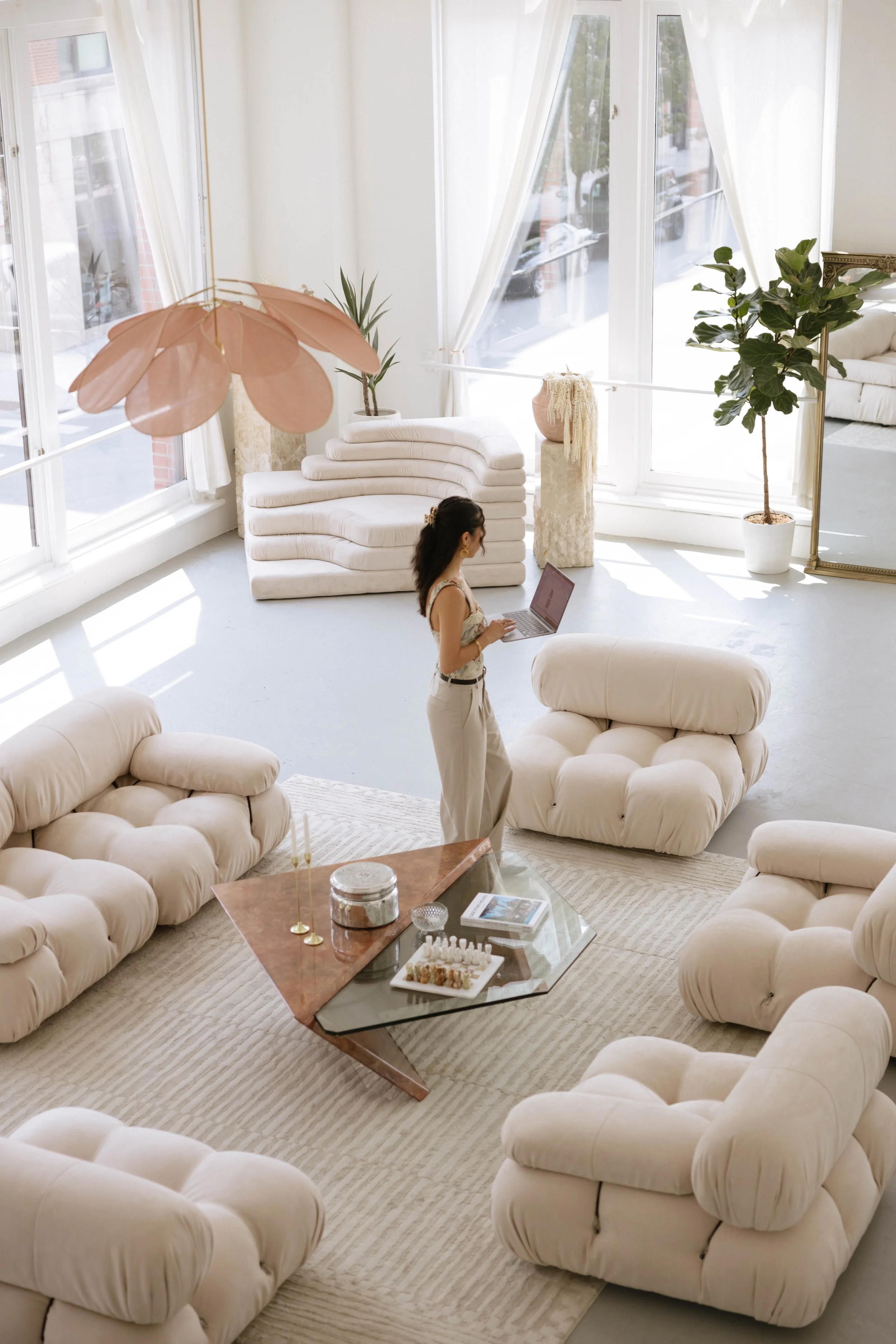 girl on computer in brightly lit studio