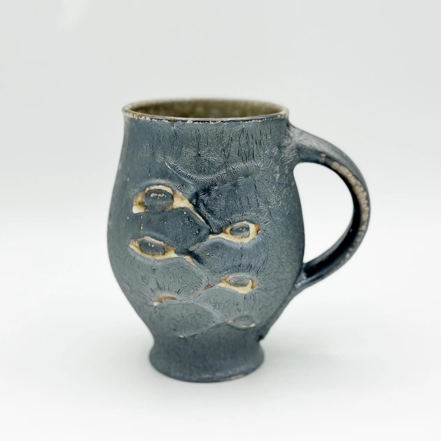 Here&rsquo;s a mug I made inspired by the elegant curves of the tulip bulb. 

There are a few dozen of these wood fired beauties available in my Etsy shop, each with unique slip trailing and surface character determined by their positioning during th