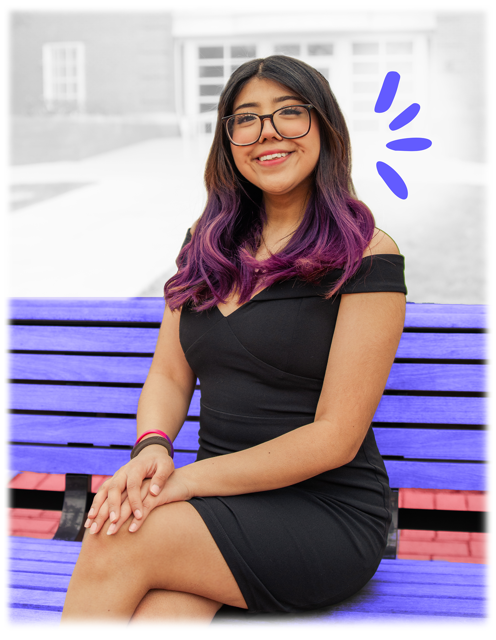 woman sitting on bench with her legs crossed and hands folded on her lap. she is smiling.