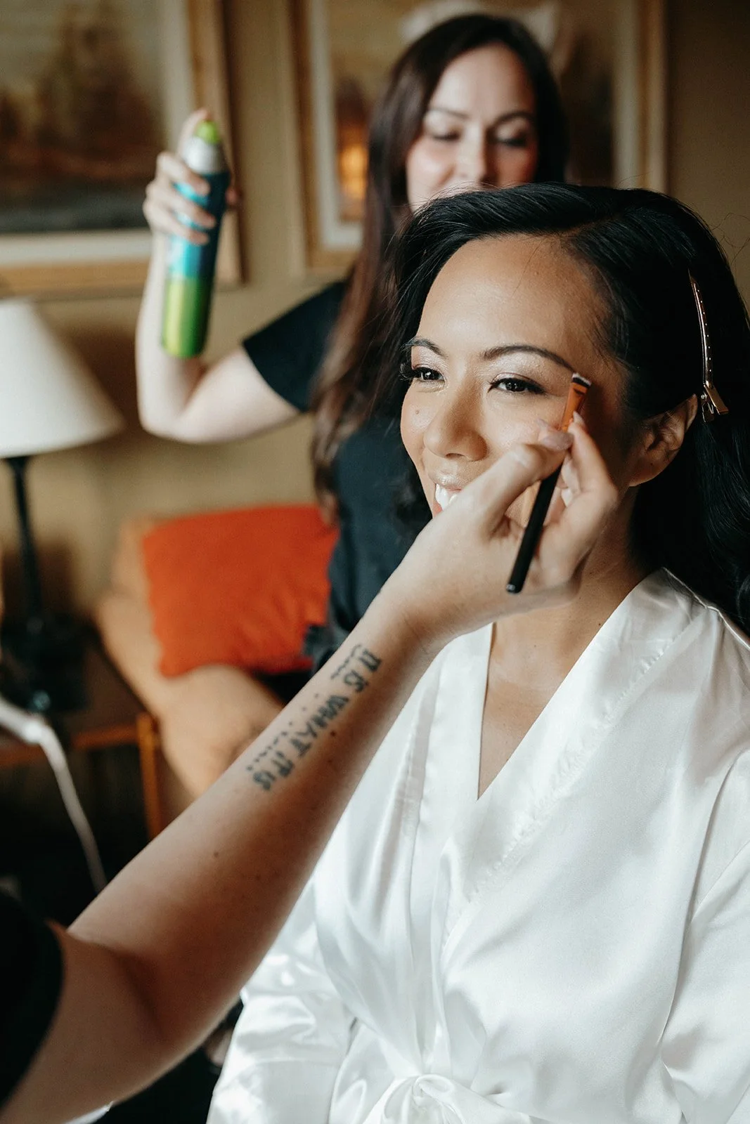 Bride smiling while getting her hair and makeup done for a wedding in Suncadia Resort Washington