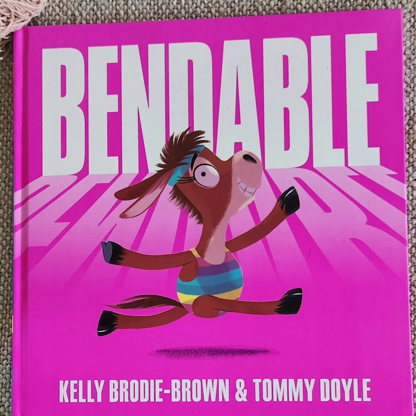 Bendable by Kelly Brodie-Brown and Tommy Doyle

Julie is a mule who, through persistence, defies all expectations of what a mule can do. She watches others in the gymnasium and is inspired by their grace, movement and balance. 

Although others doubt