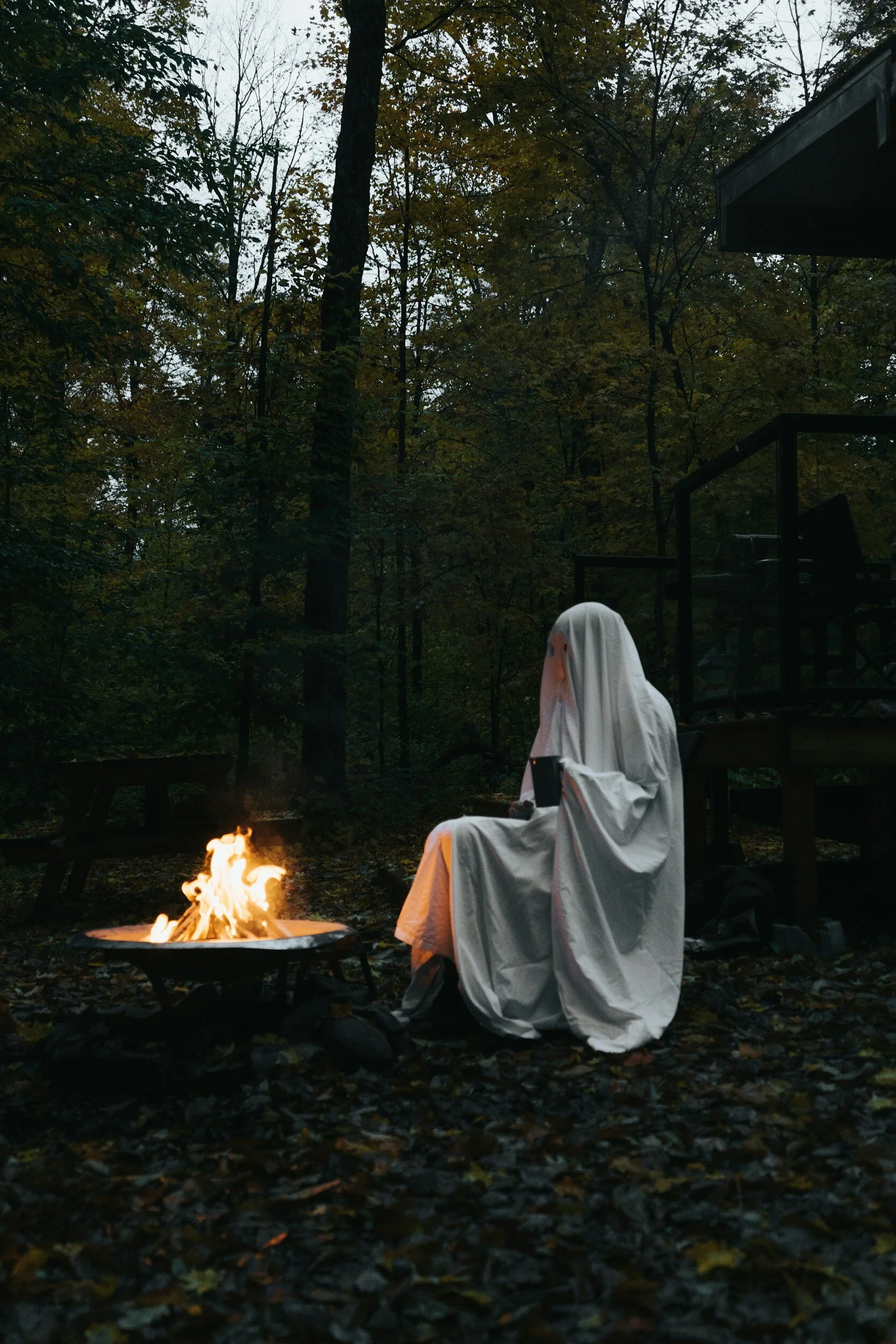 ghost sitting around a campfire listening to scary stories