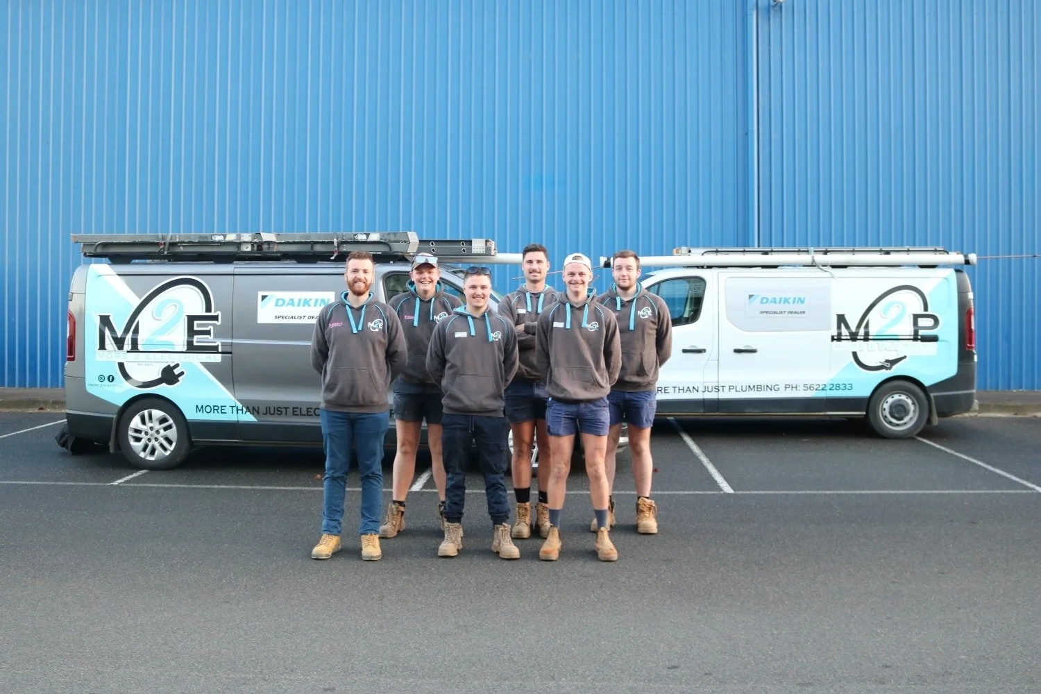 The More 2 Electrical team in Warragul standing with their Work Vans