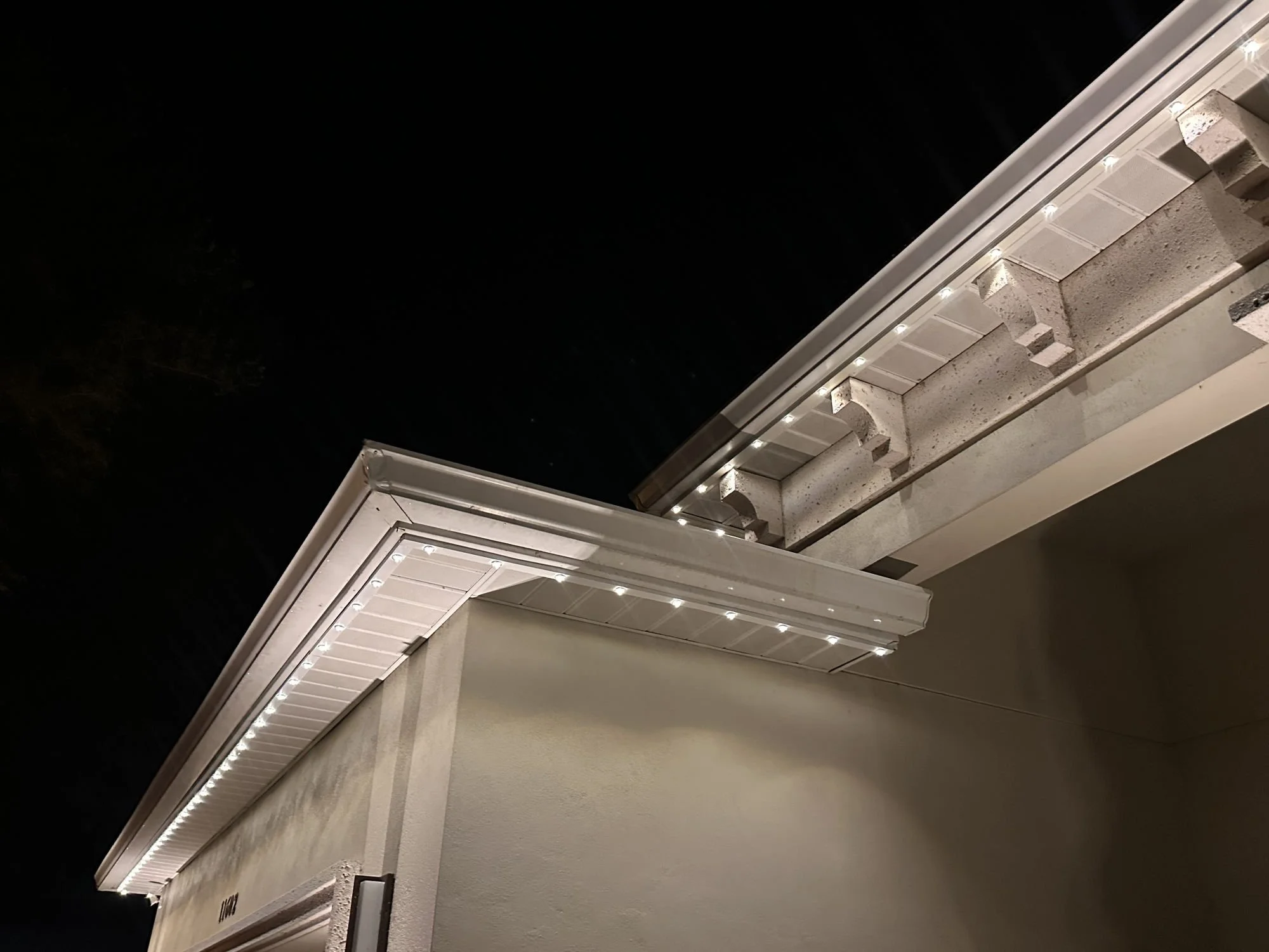 permanent roofline lighting on soffit of a house at night in Orange County FL