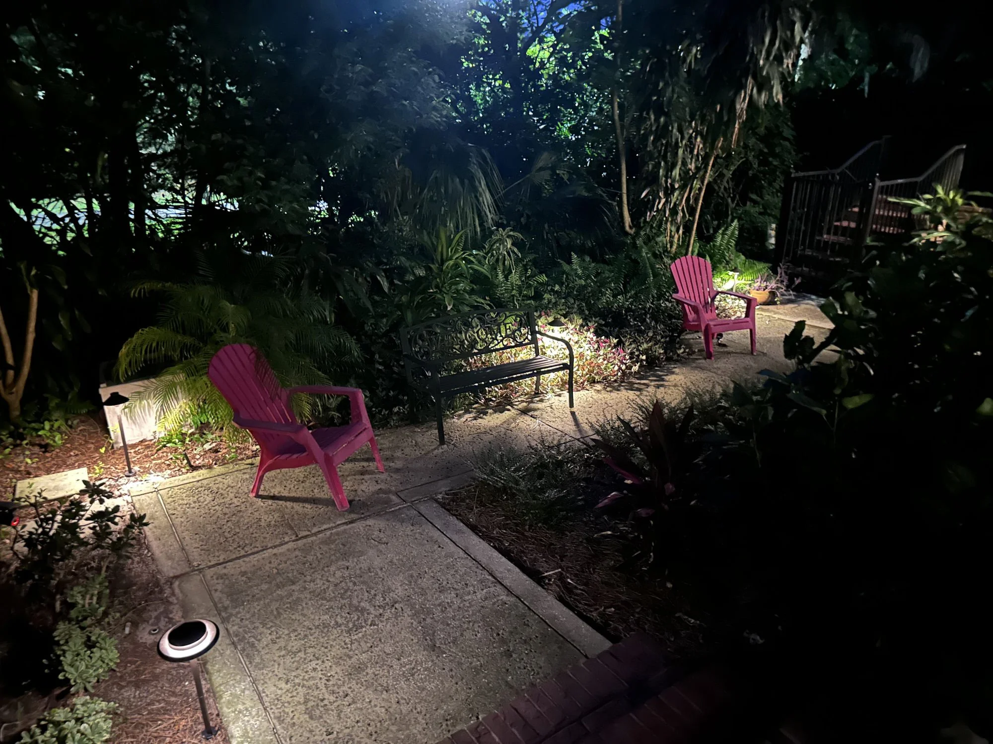 A pathway at night time illuminated with hat style fixtures in Orlando