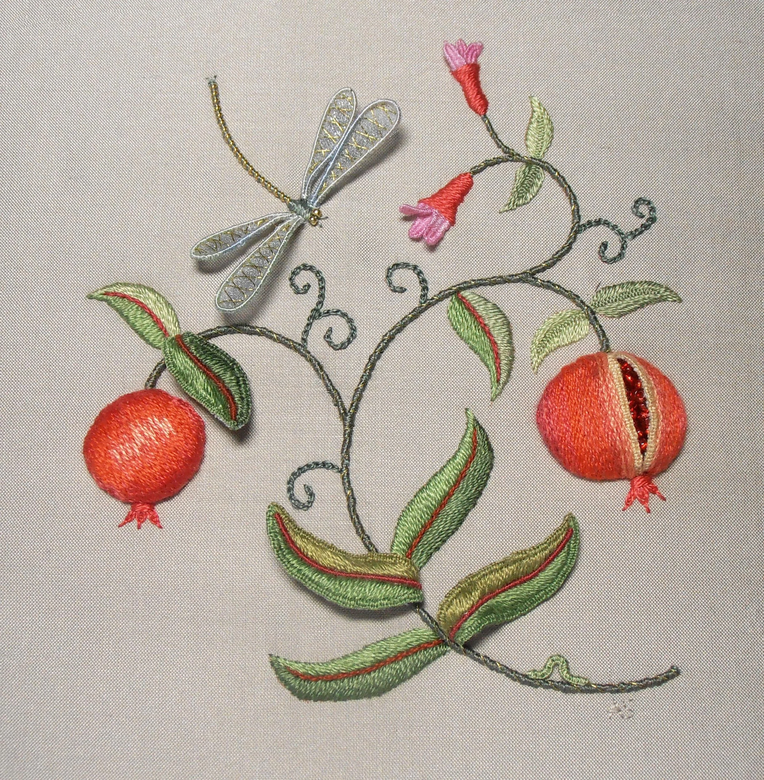 Embroidered stumpwork panel of bright orange pomegranates, green leaves and a silver and gold dragonfly.