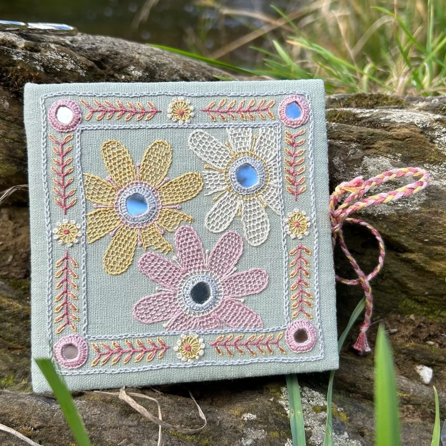 Sage green needle book embroidered with elegant design of daisies using shisha mirrors by Anna Scott.jpg