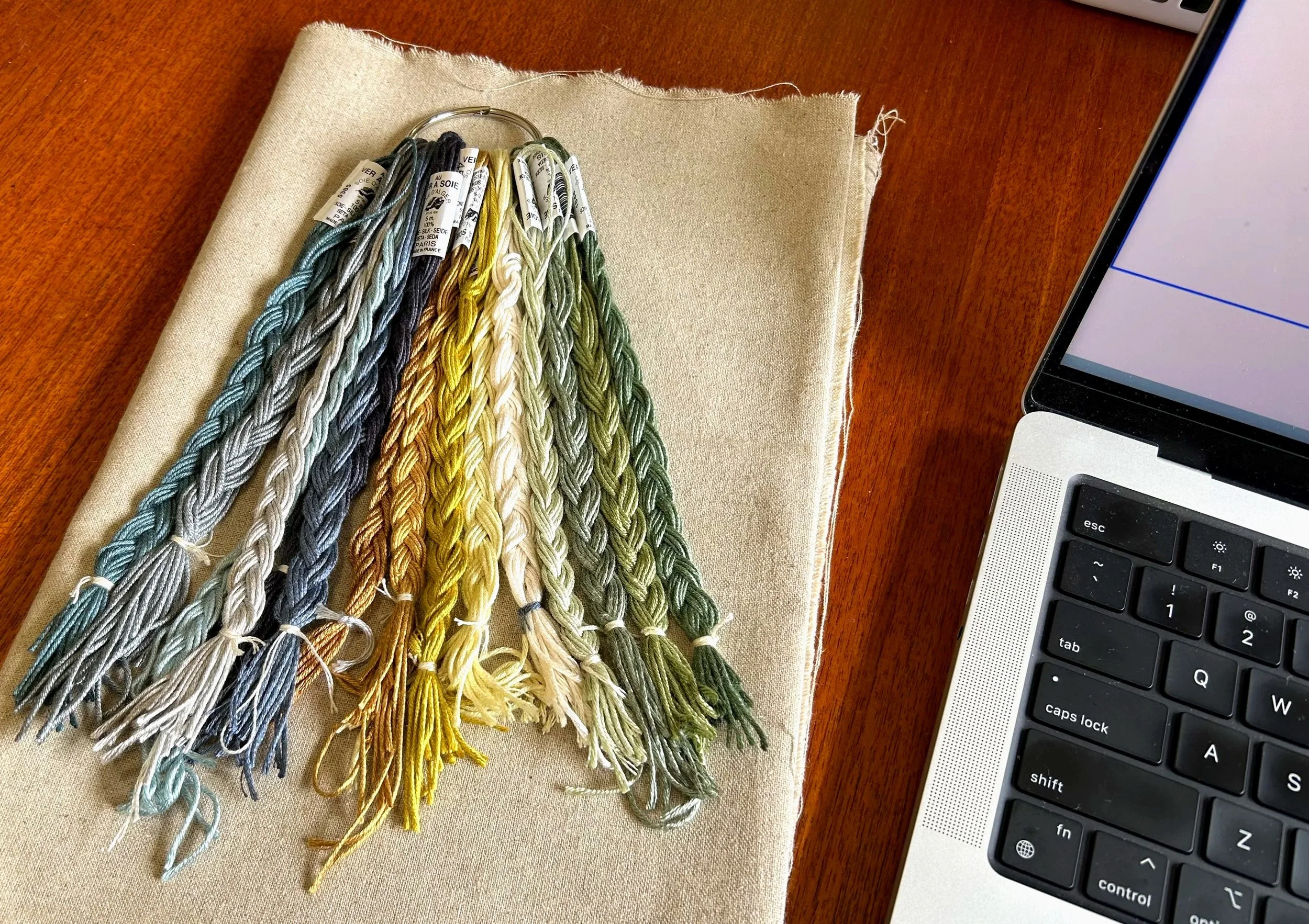 Silk threads and linen fabric, ready for embroidery.