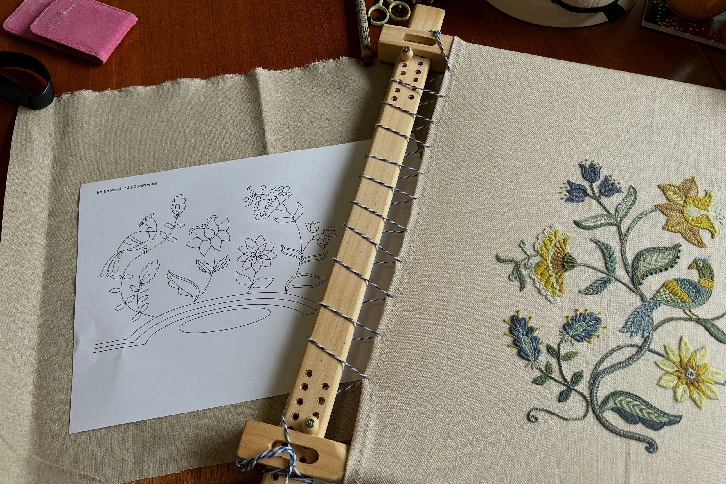 Crewel embroidery on frame and secondary design ready to be transferred onto fabric.