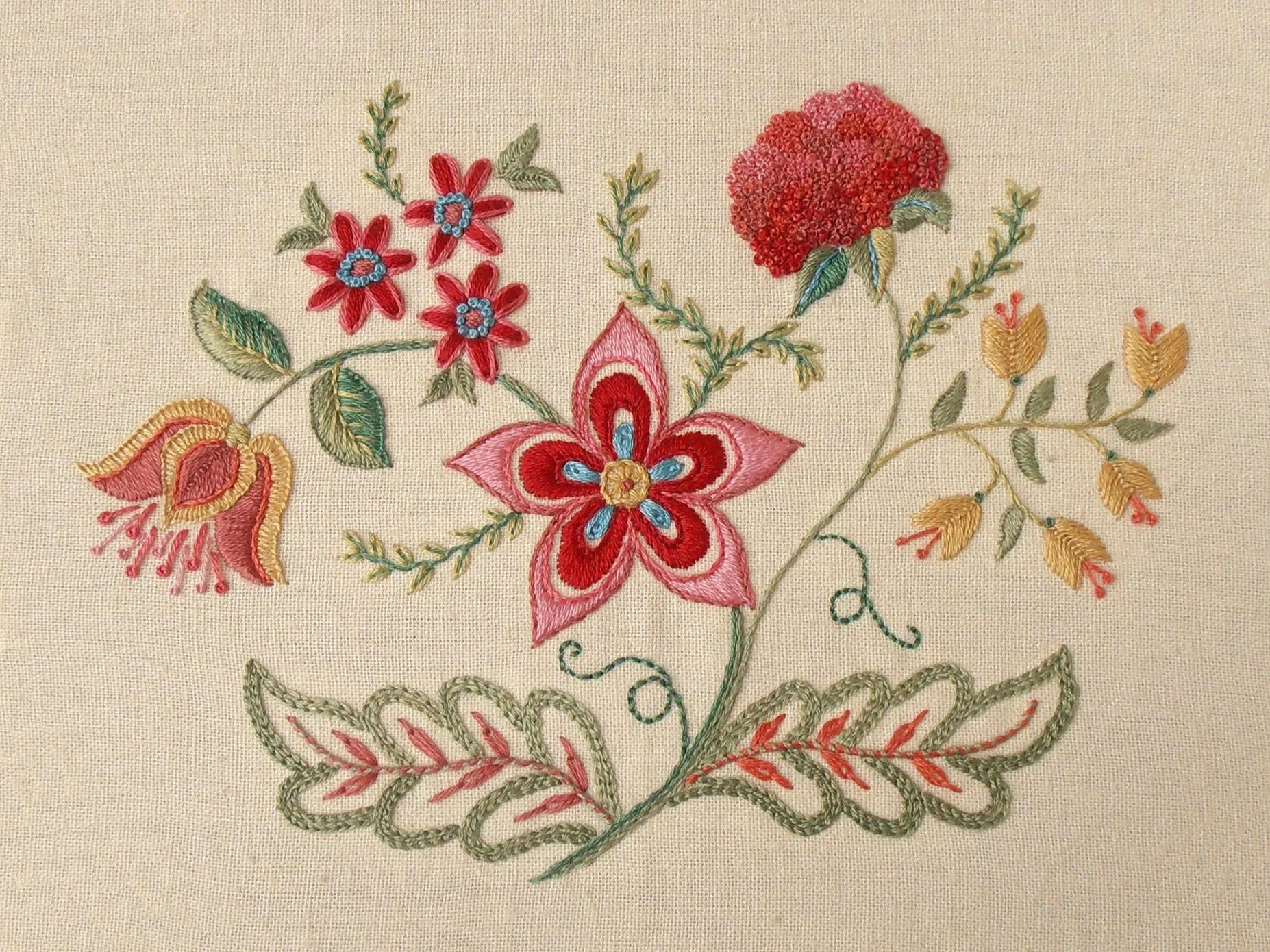 Hand embroidery with flowers in burnt summer shades. Stitched in stranded cotton on linen.