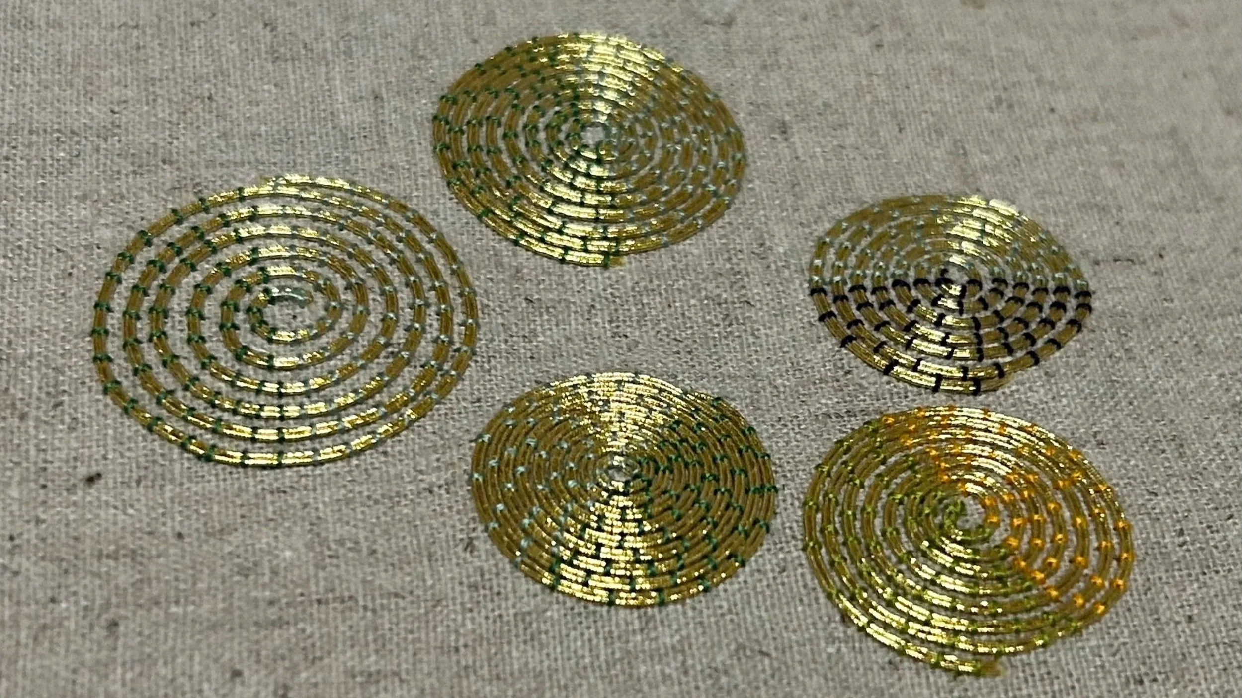 Metal thread spirals stitches with coloured silks by Anna Scott