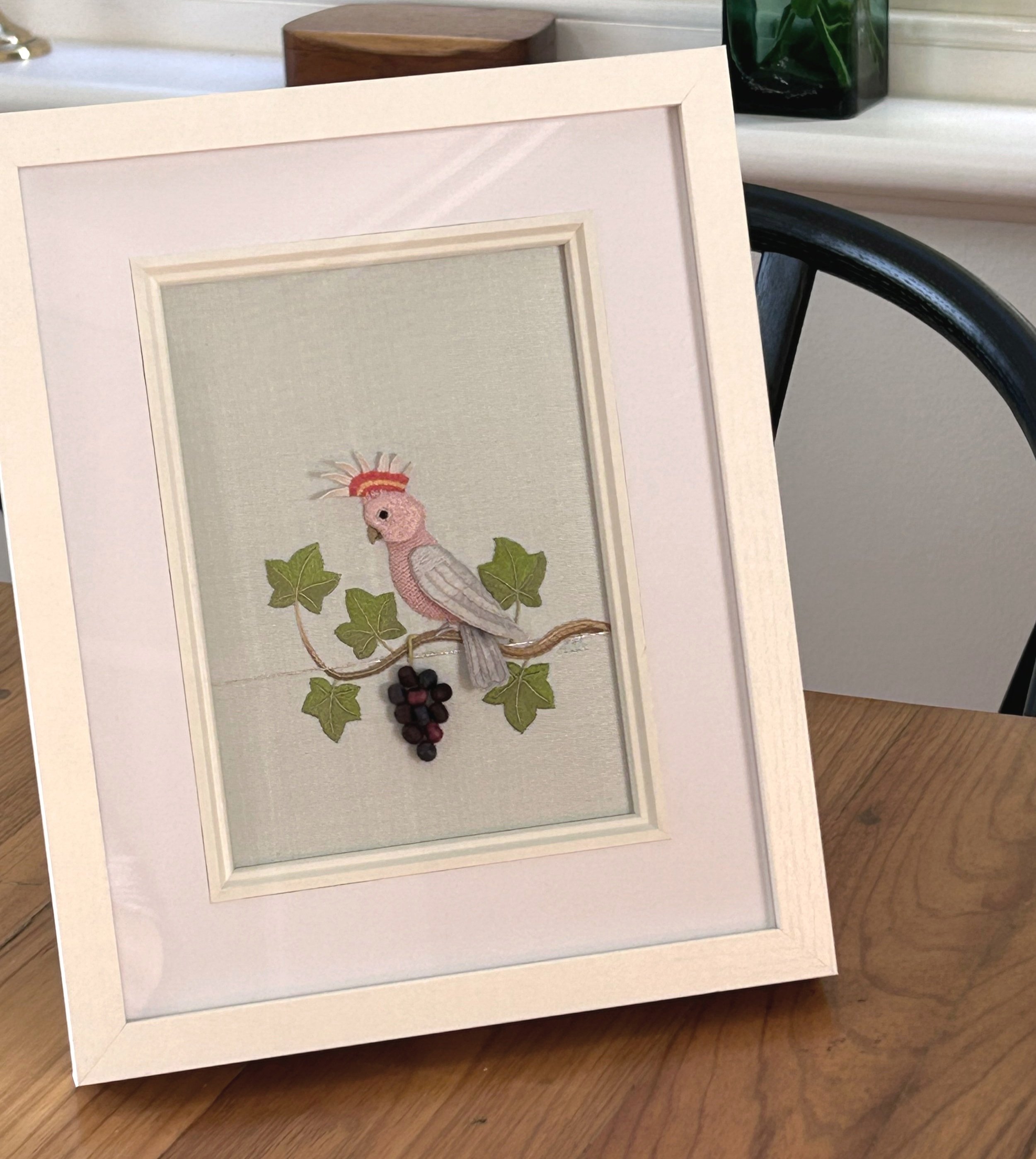 Framed picture. Raised Embroidery Kit - RIPE FOR PICKING featuring pink cockatoo with colourful crest sitting on a vine with ripe grapes.