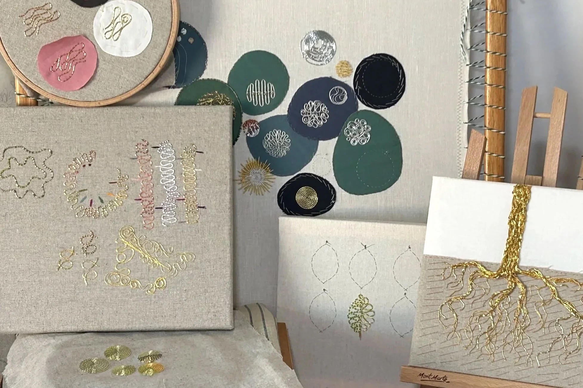 Collection of frames and hoops with metal thread embroidery samplers by Anna Scott